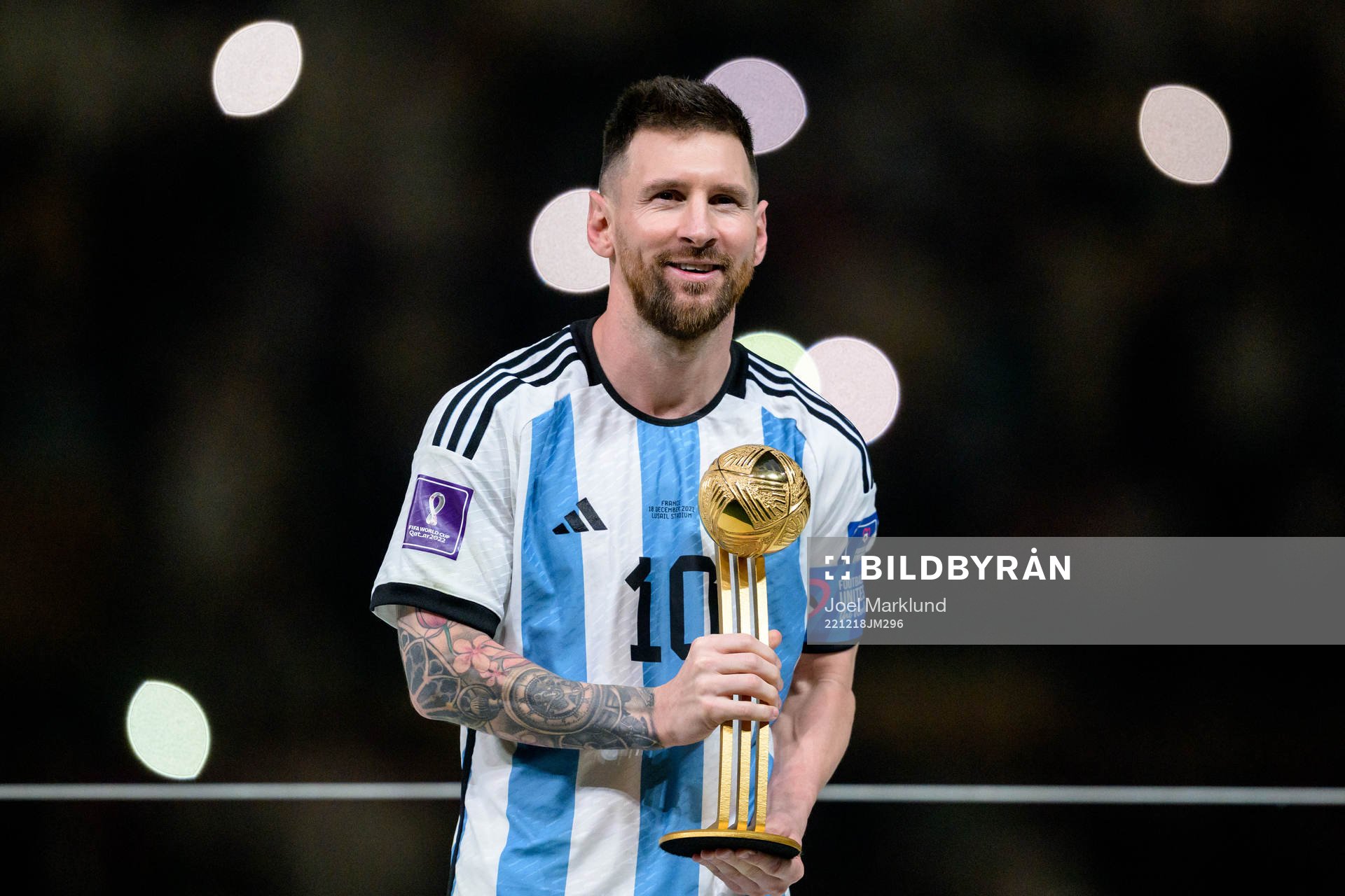 Lionel Messi of Argentina celebrates with his award