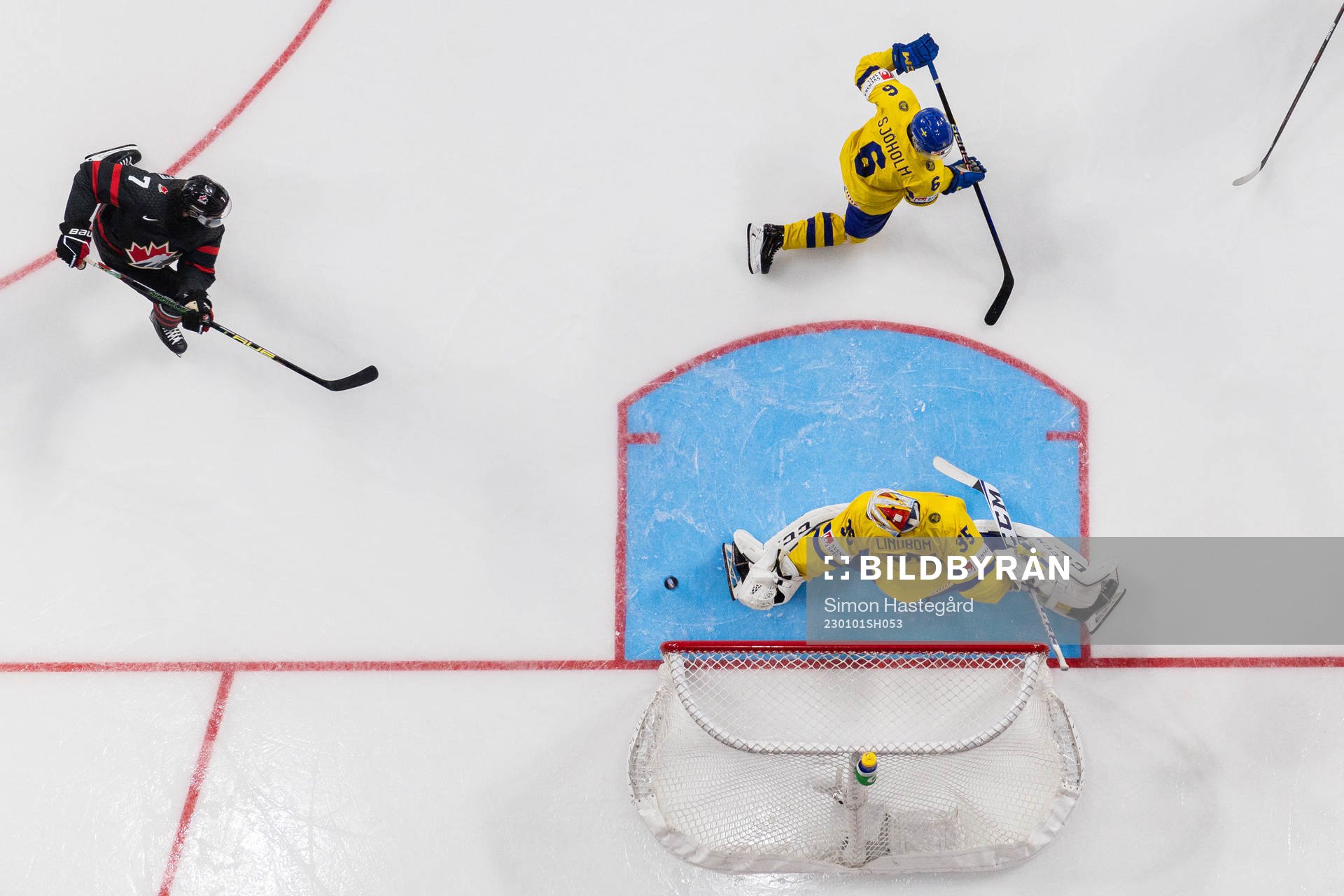 Brennan Othmann of Canada scores the 5-1 goal behind
