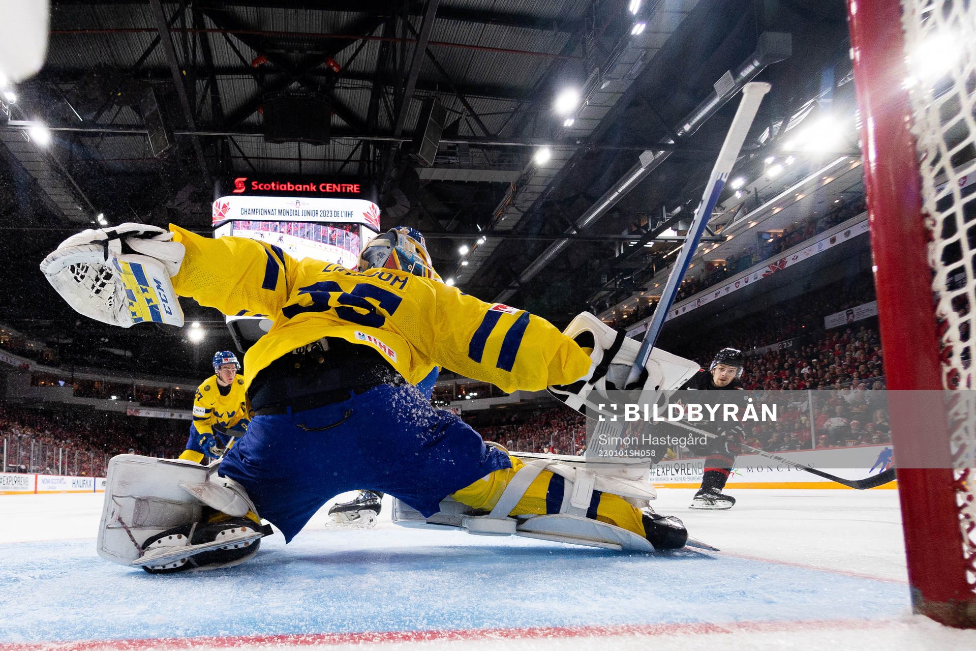 Brennan Othmann of Canada scores the 4-1 goal behind