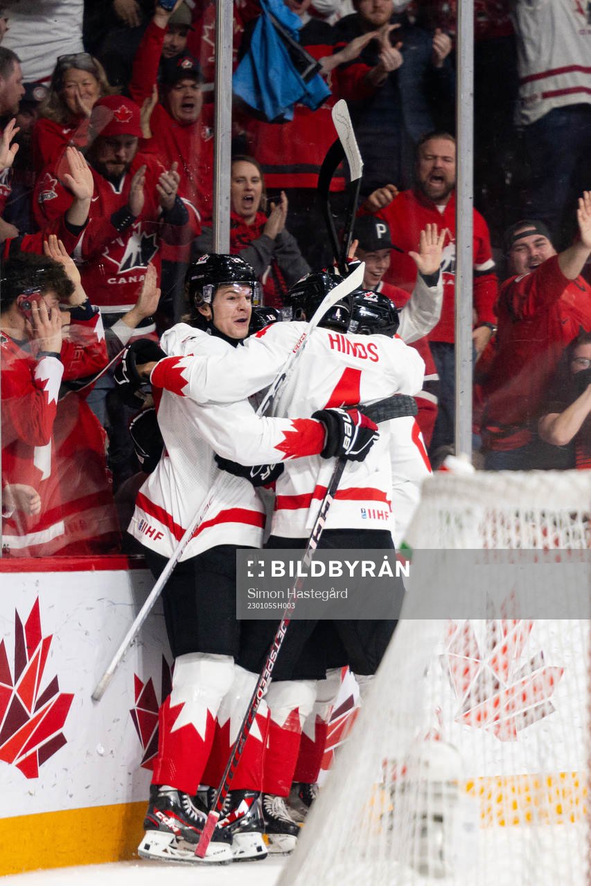 Ethan Del Mastro and Connor Bedard of Canada celebrates the