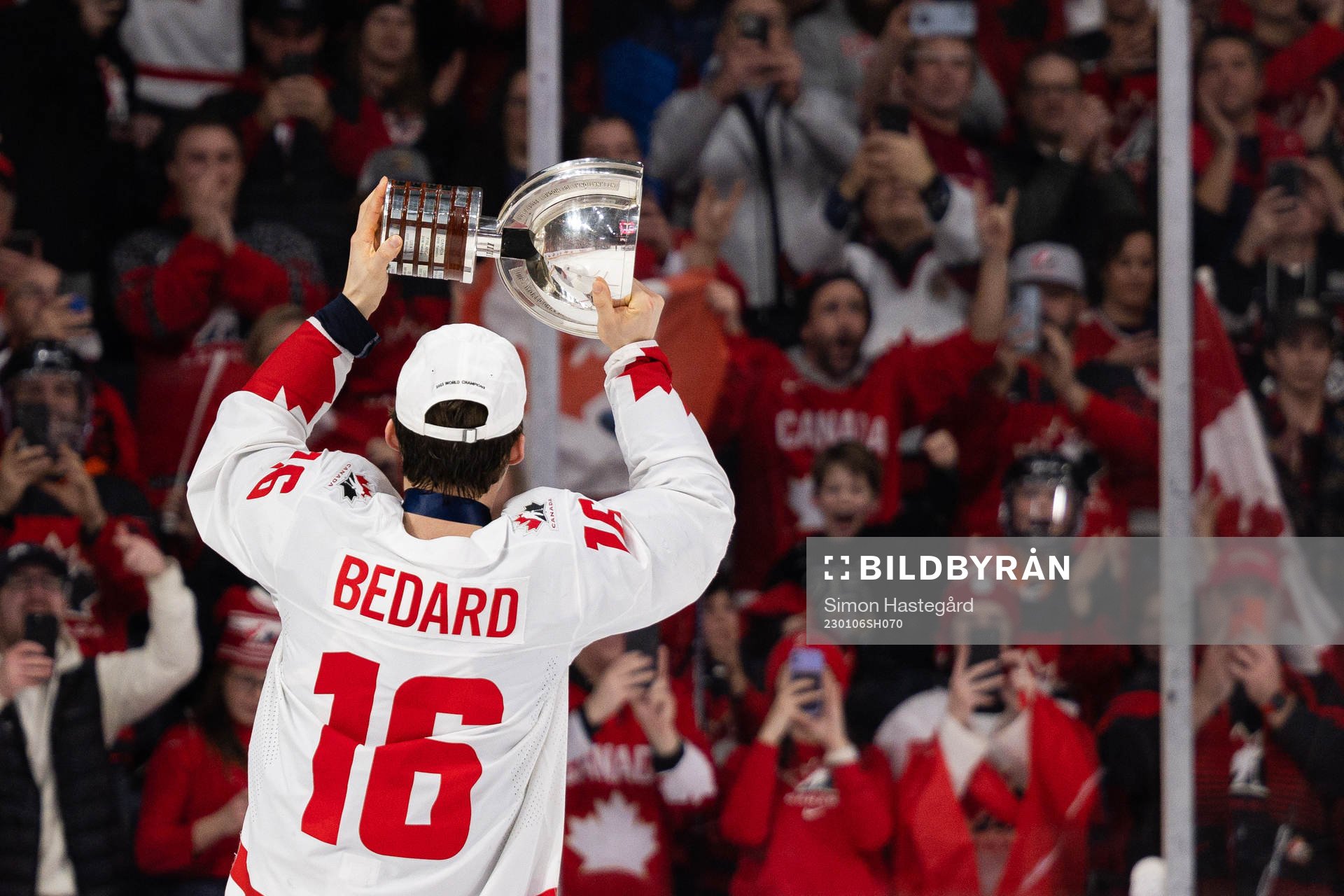 Connor Bedard of Canada celebrates with the trophy
