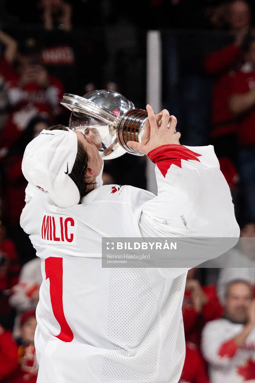 Goalkeeper Thomas Milic of Canada celebrates with the trophy