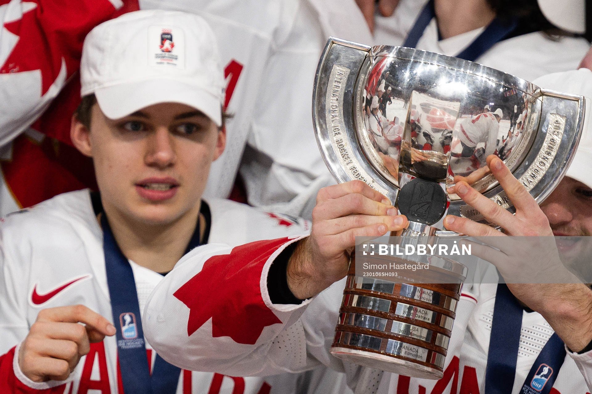 Connor Bedard of Canada celebrates with the trophy