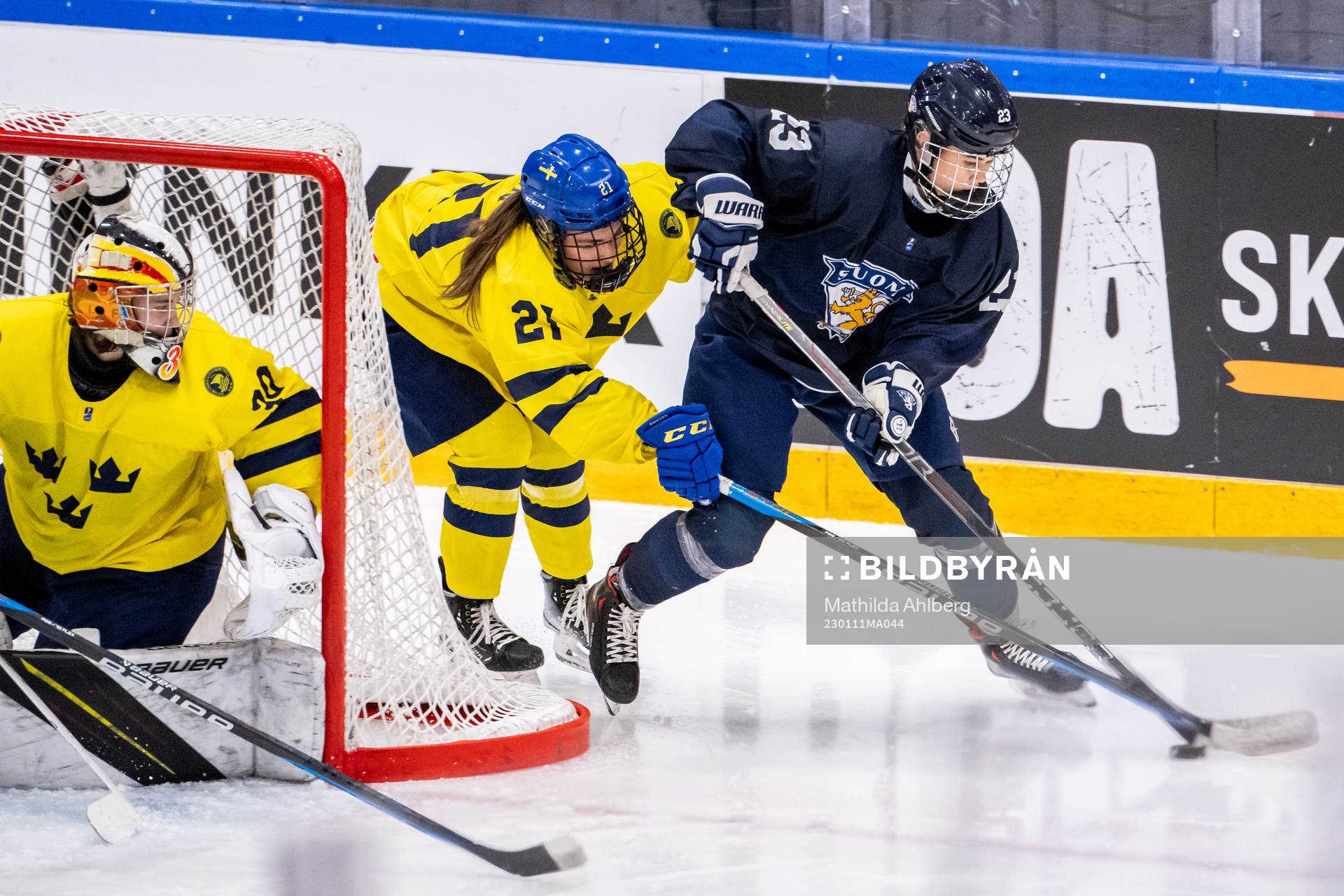 Erica Korhonen of Finland against Emma Rehn and goaltender