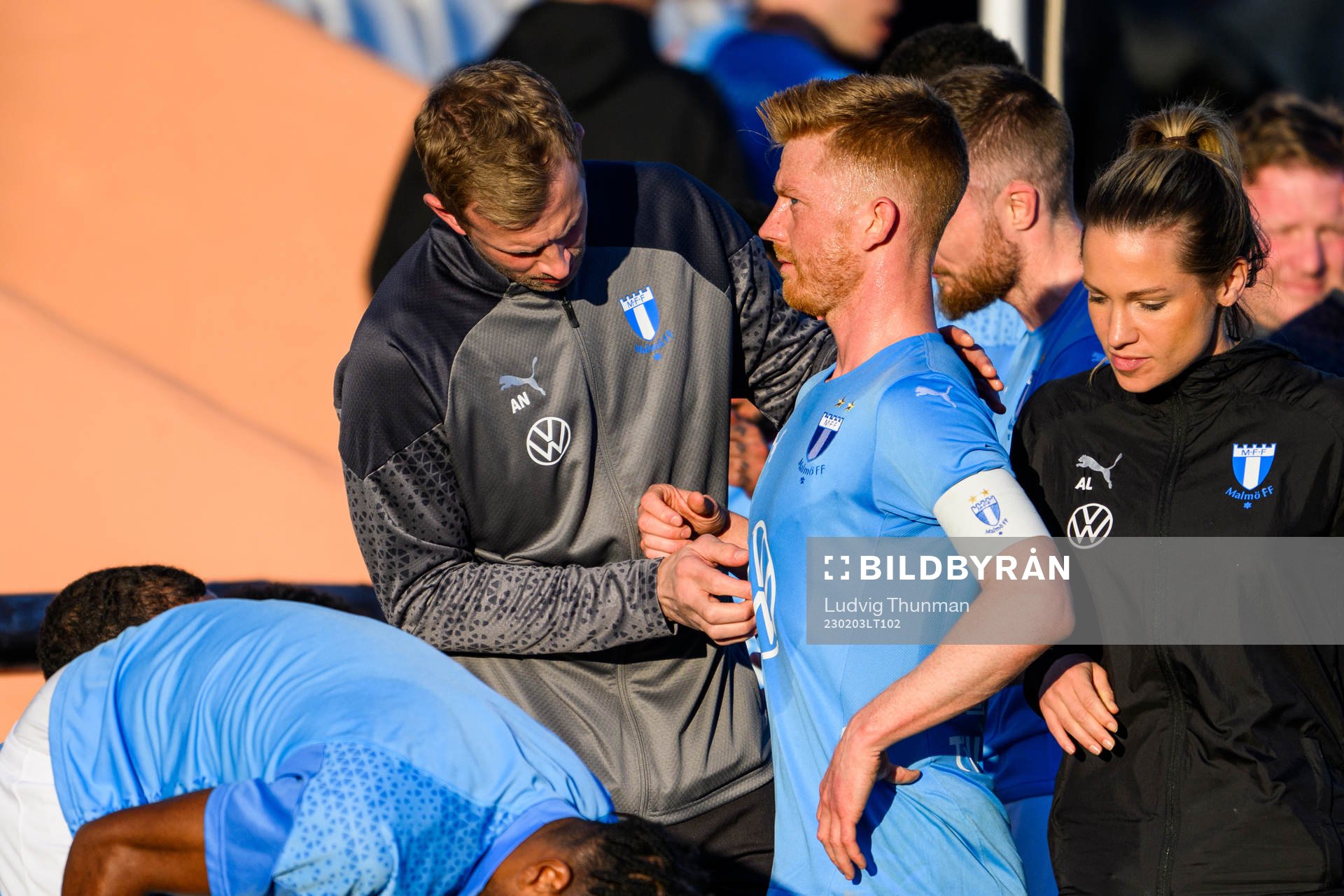 Physiotherapist Jesper Robertsson looks over Anders