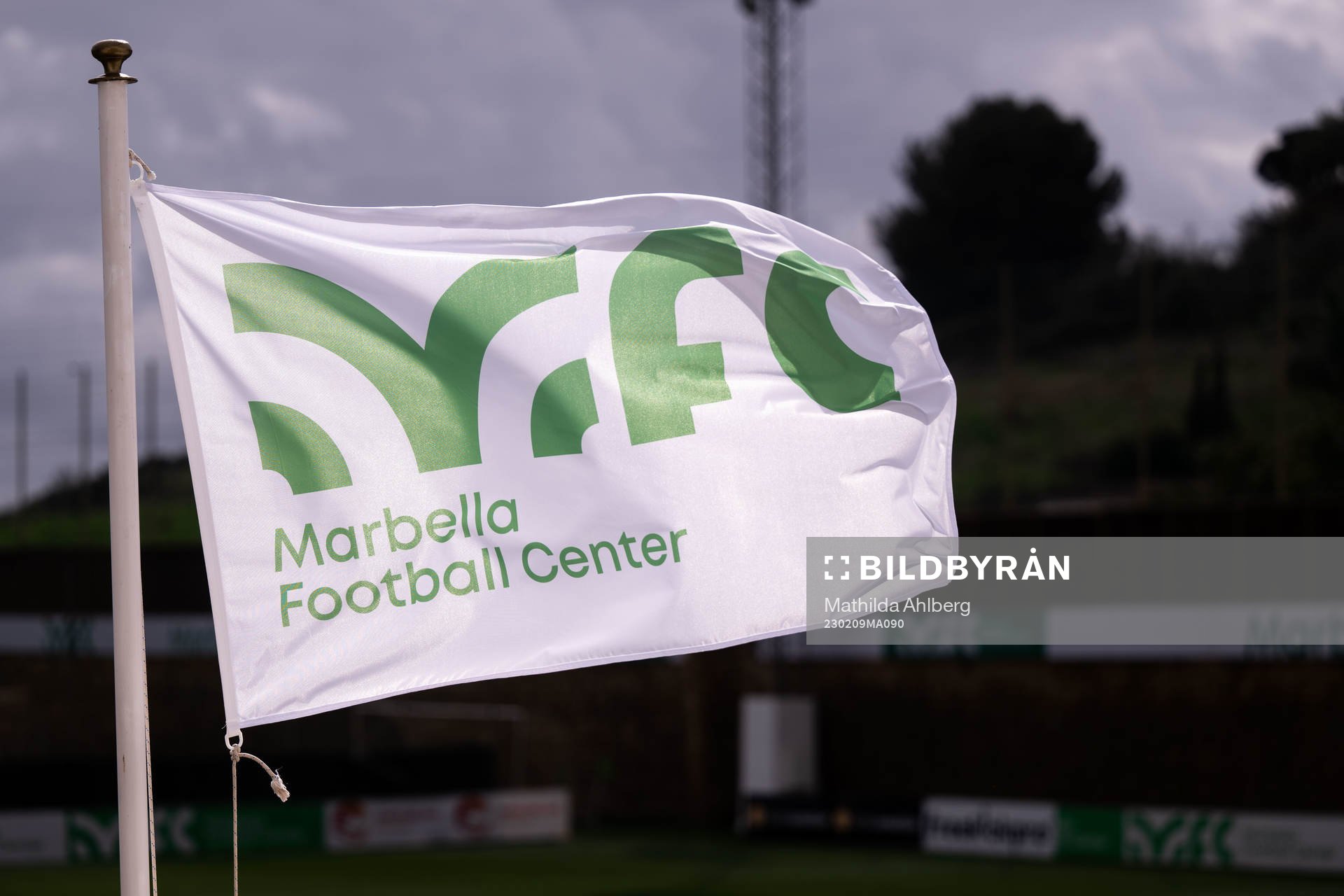 Flags with the Marbella Football Center logo