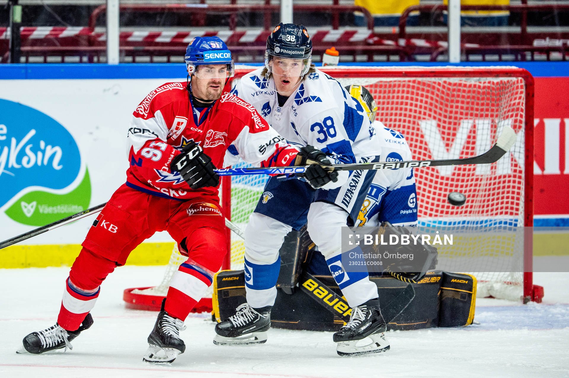Jakub Flek of Czechia and Juuso Riikola and goaltender Juha
