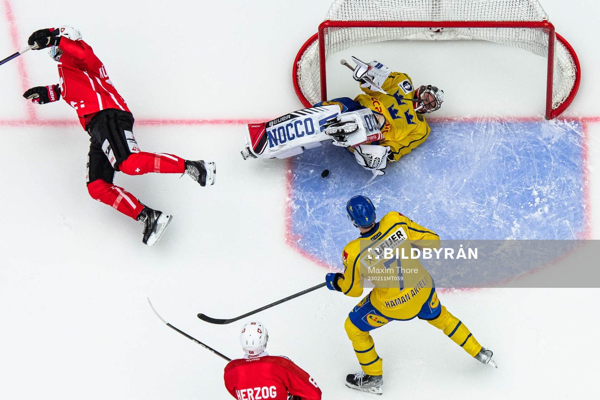Mike Kunzle of Switzerland and goalkeeper Jhonas Enroth of