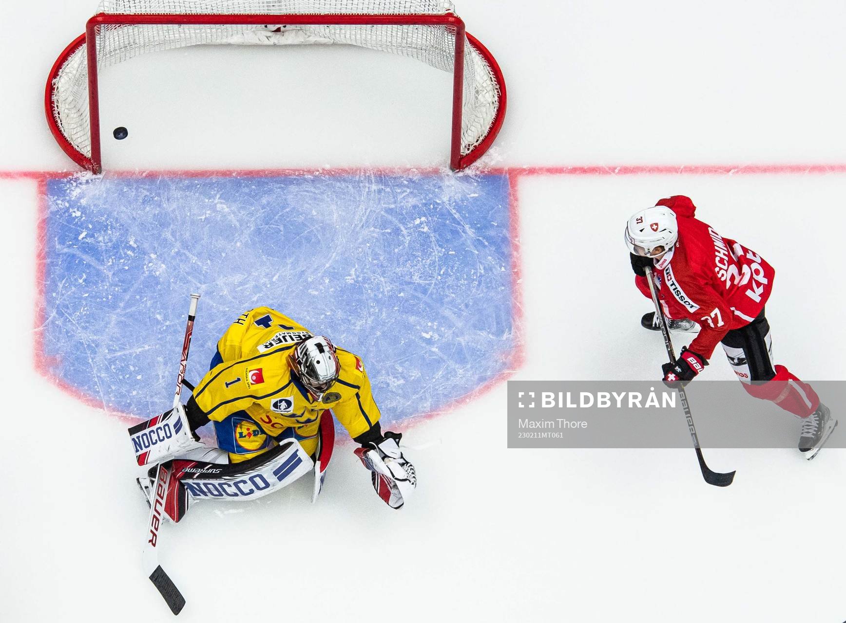Goalkeeper Jhonas Enroth of Sweden and Sandro Schmid of