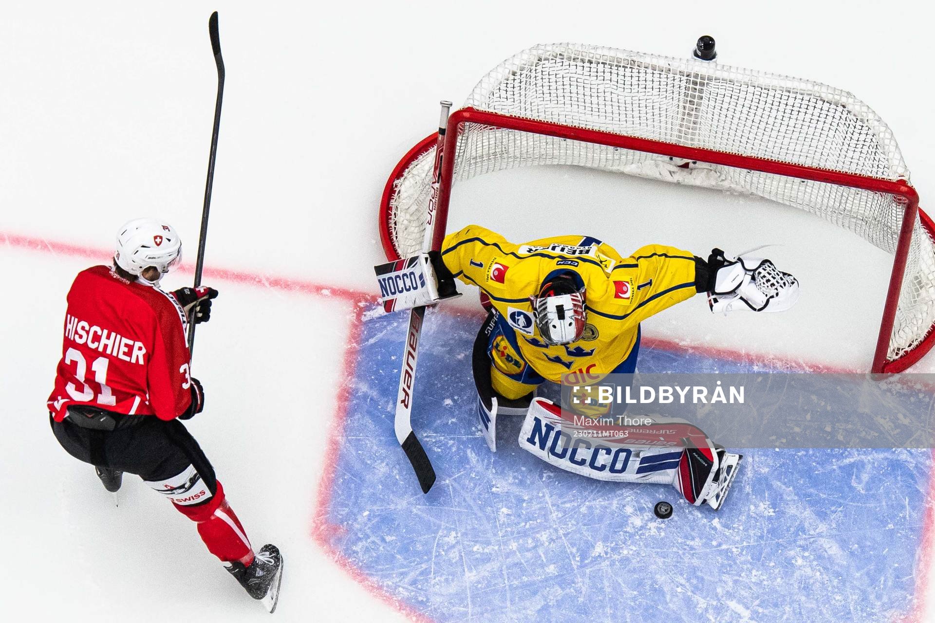 Luca Hischier of Switzerland and goalkeeper Jhonas Enroth