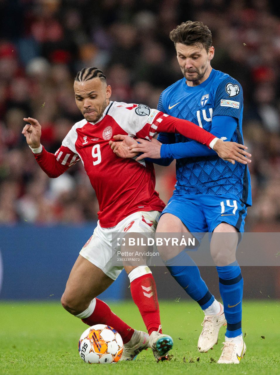 Martin Braithwaite of Denmark and Kaan Kairinen of Finland