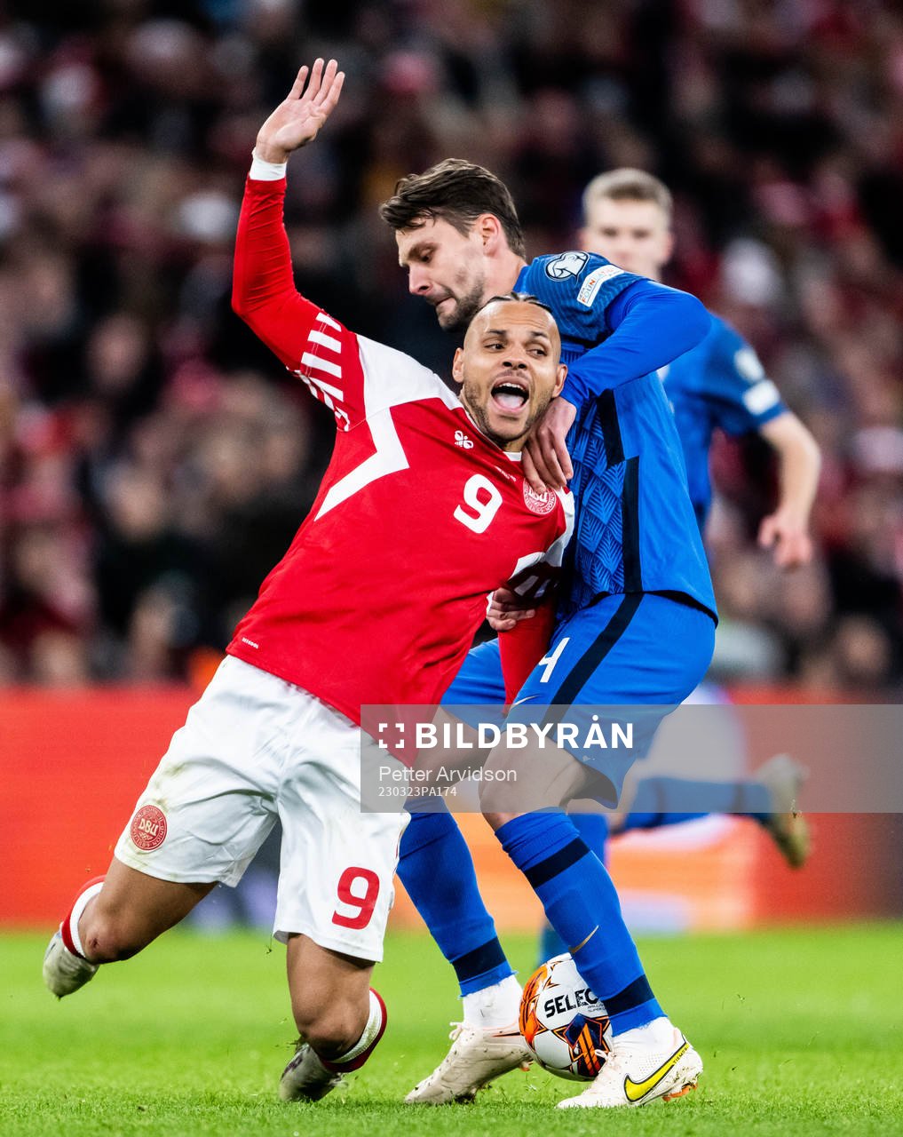 Martin Braithwaite of Denmark and Kaan Kairinen of Finland