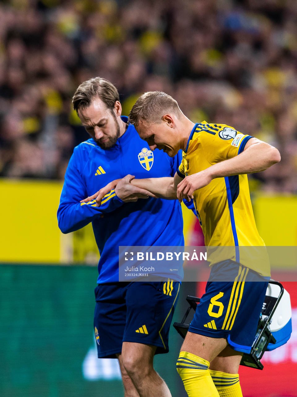 Ludvig Augustinsson of Sweden leaves the pitch due to injury