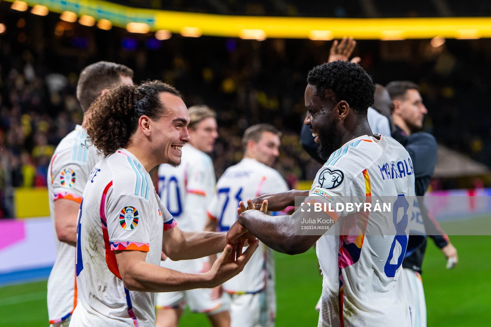Arthur Theate and Orel Mangala of Belgium celebrate