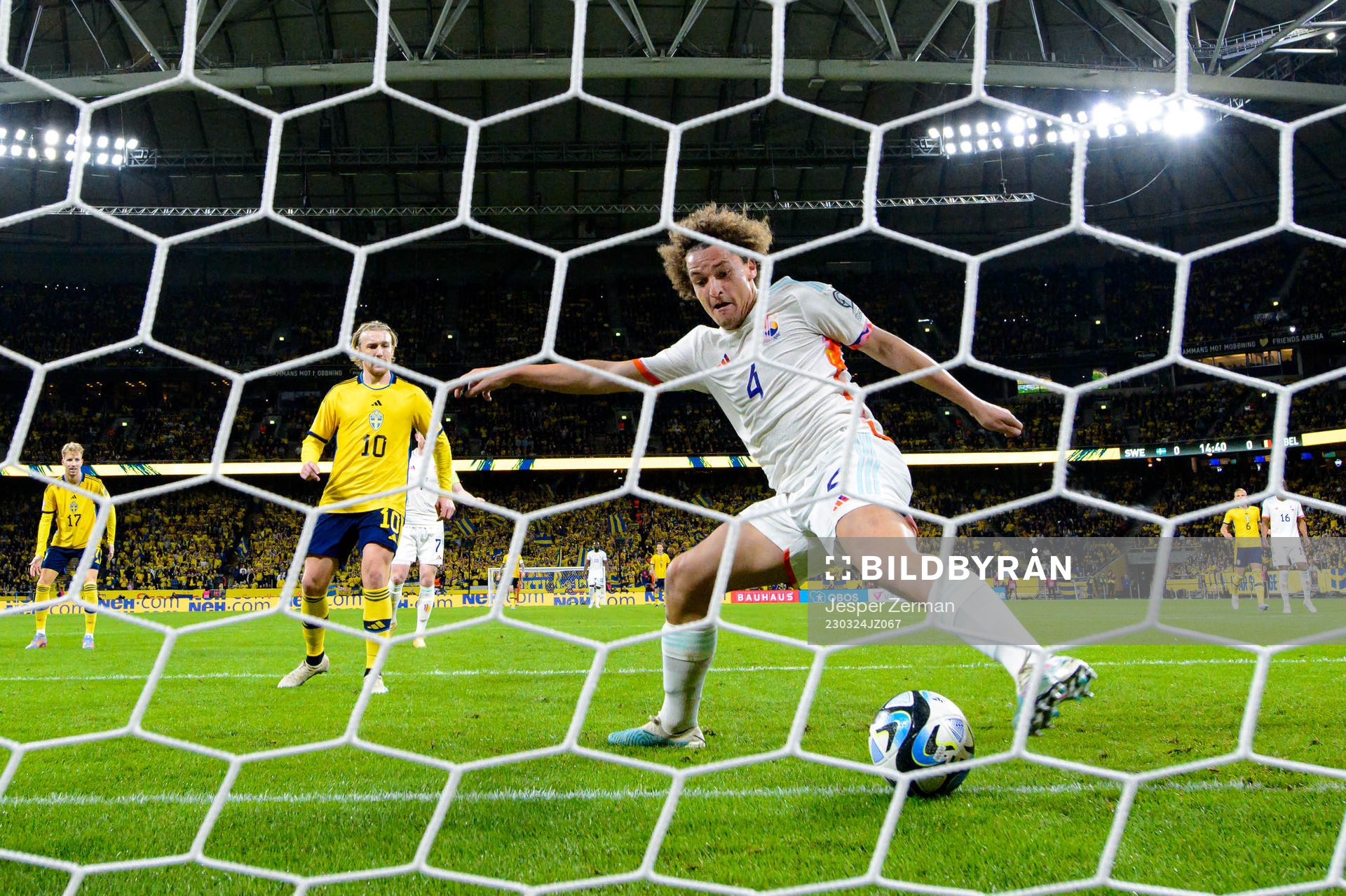 Wout Faes of Belgium stops the ball