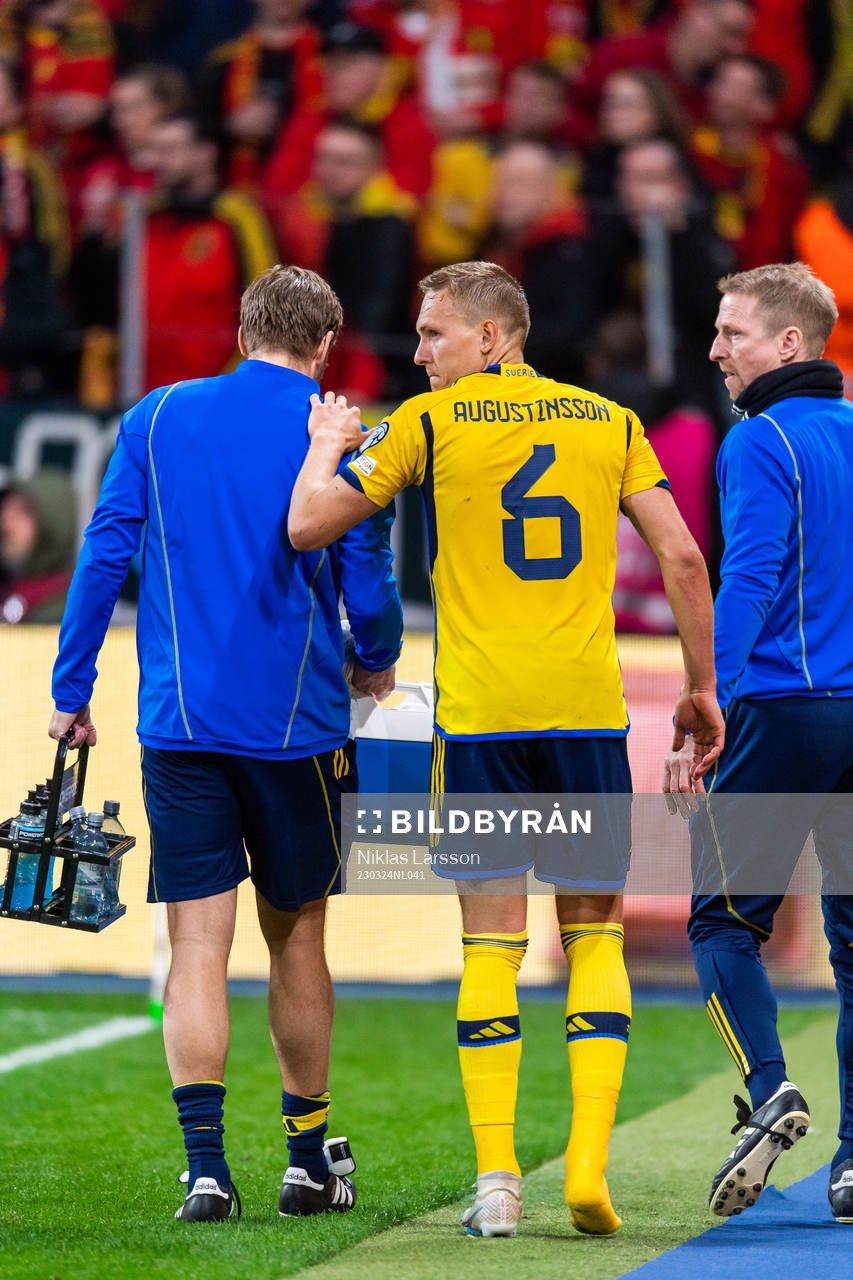 Ludvig Augustinsson of Sweden leaves the pitch due to injury