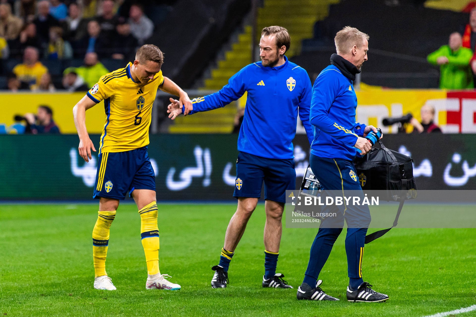 Ludvig Augustinsson of Sweden leaves the pitch due to injury