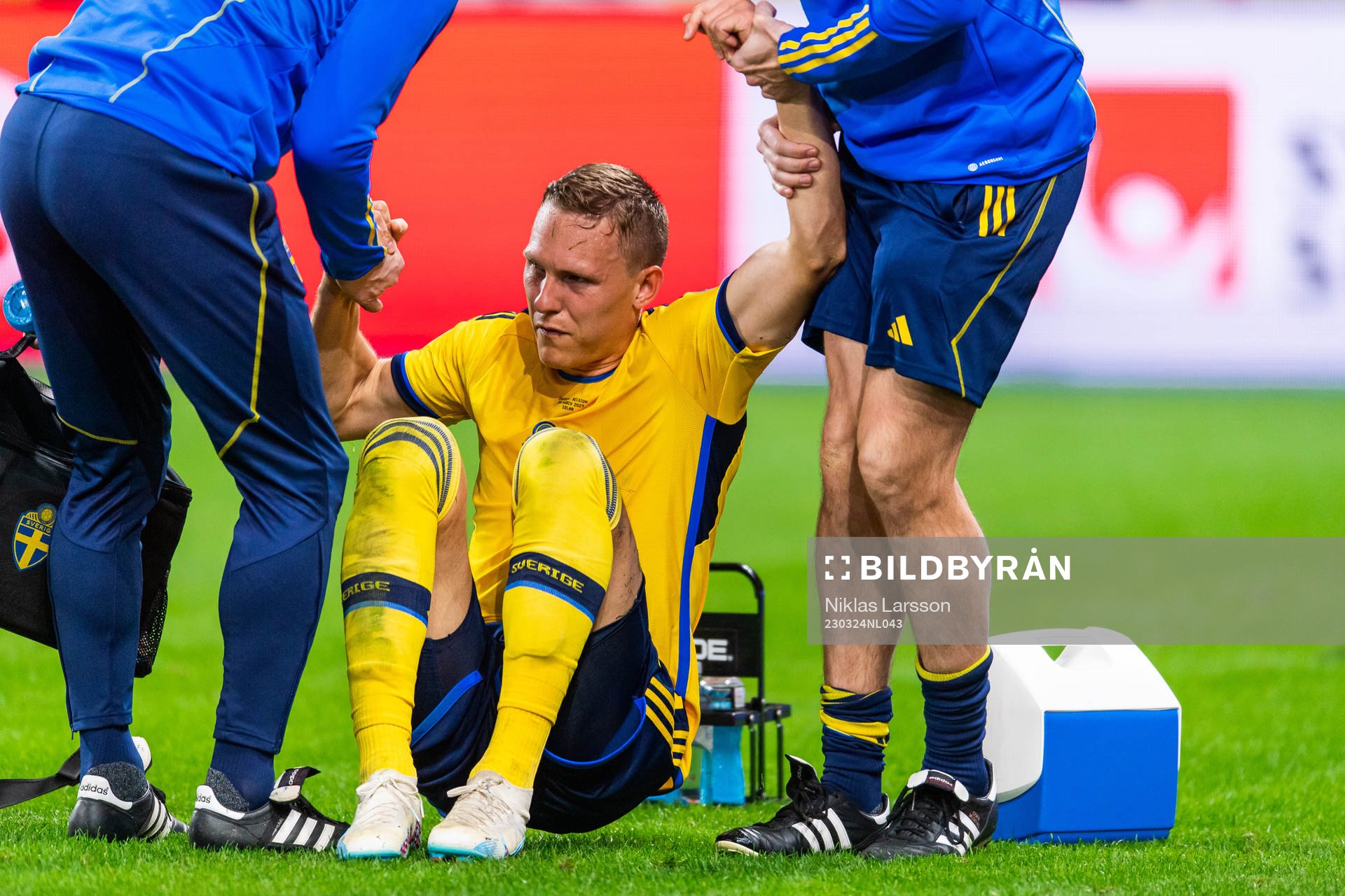 Ludvig Augustinsson of Sweden leaves the pitch due to injury