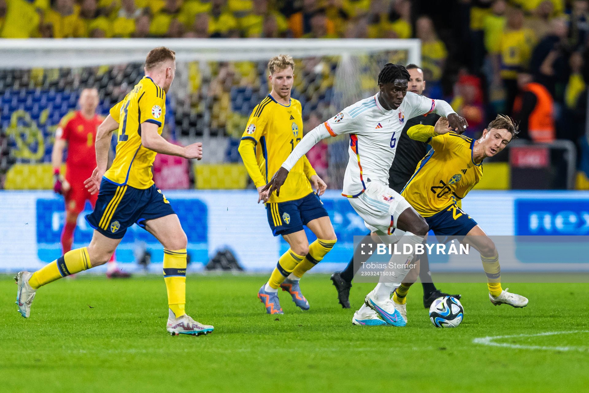 Amadou Onana of Belgium and Kristoffer Olsson of Sweden