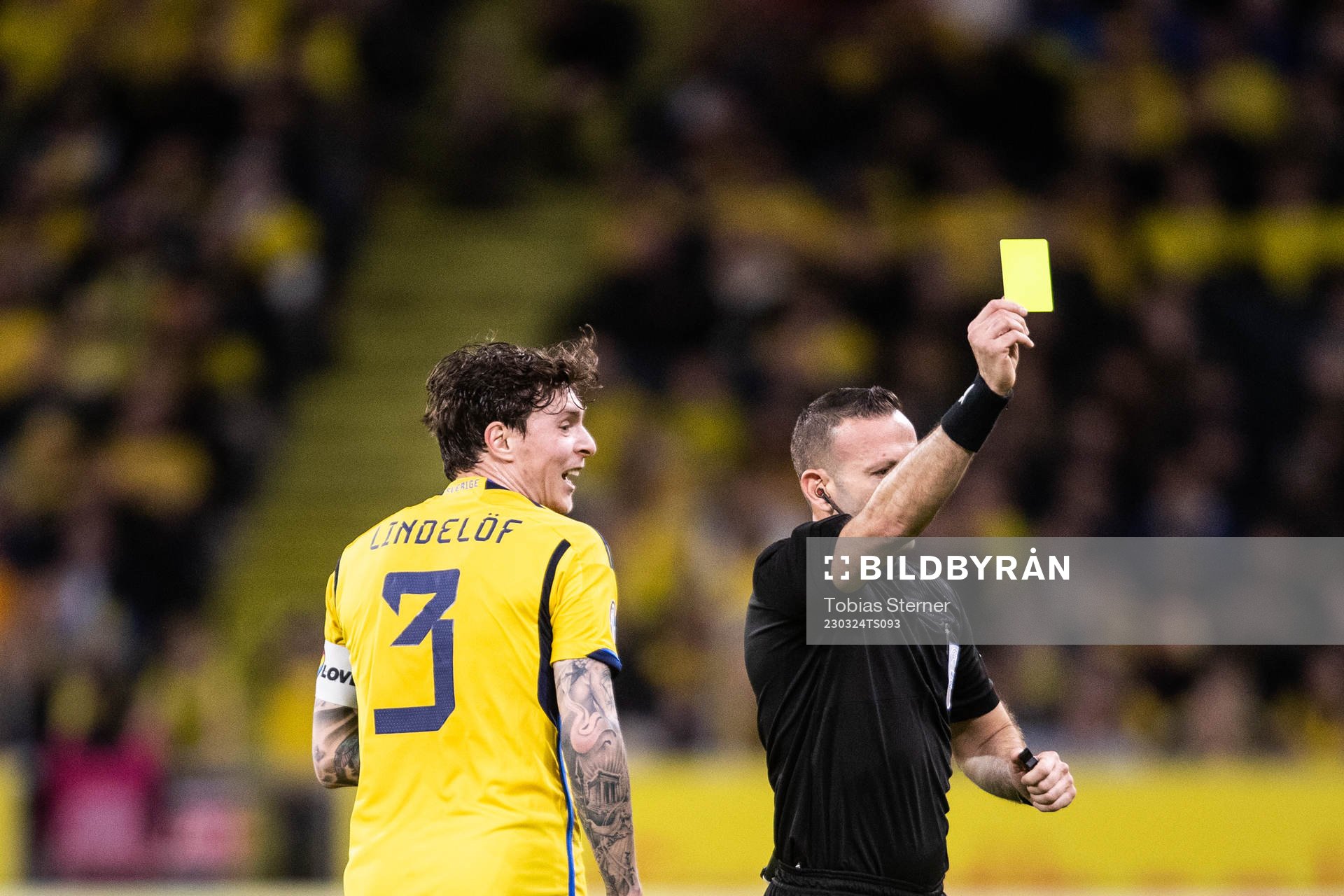 Victor Nilsson Lindelöf of Sweden receives a yellow card