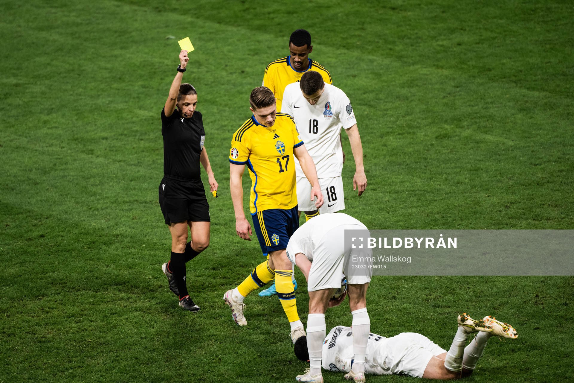 Viktor Gyökeres of Sweden receives a yellow card by