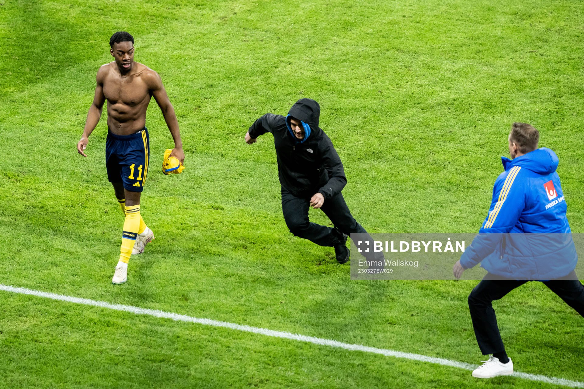 A pitch invader and Anthony Elanga of Sweden