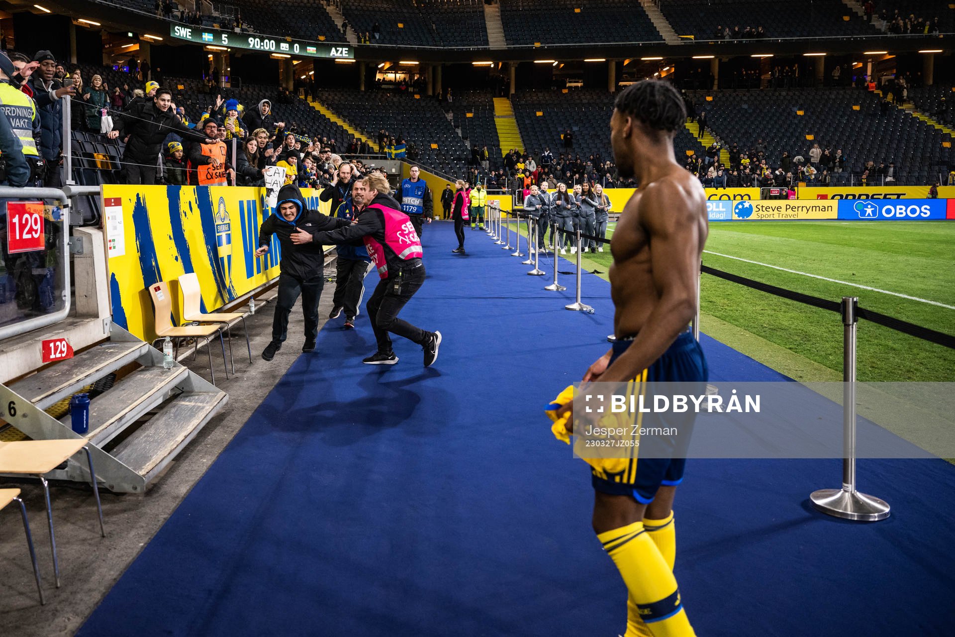 A pitch invader and Anthony Elanga of Sweden