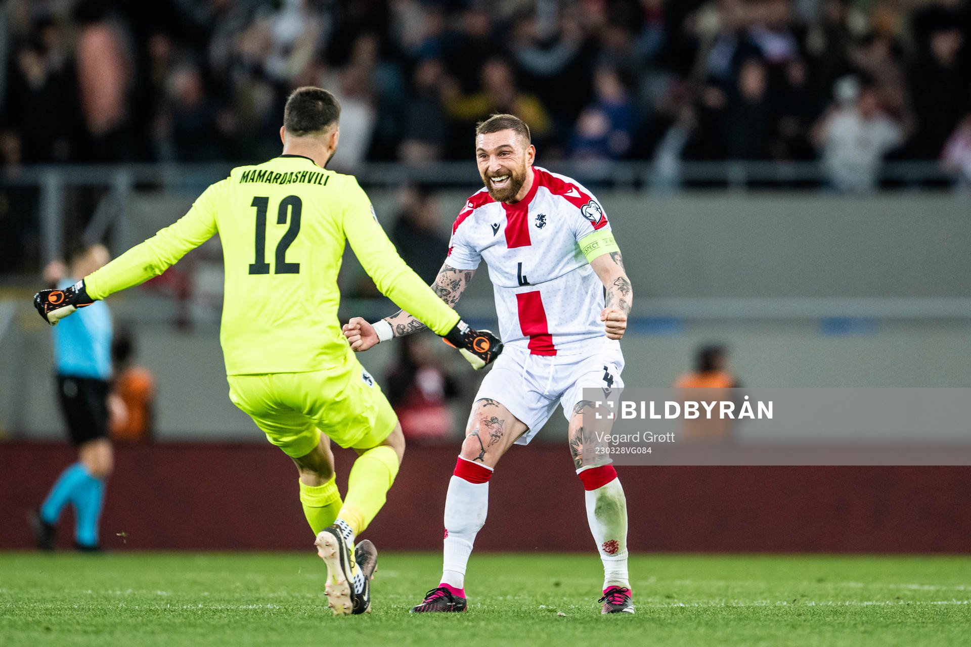 goalkeeper Giorgi Mamardashvili and Guram Kashia of Georgia celebrate after 1-1 during the UEFA Euro Qualifier football match between Georgia and Norway on March 28, 2023 in Batumi.