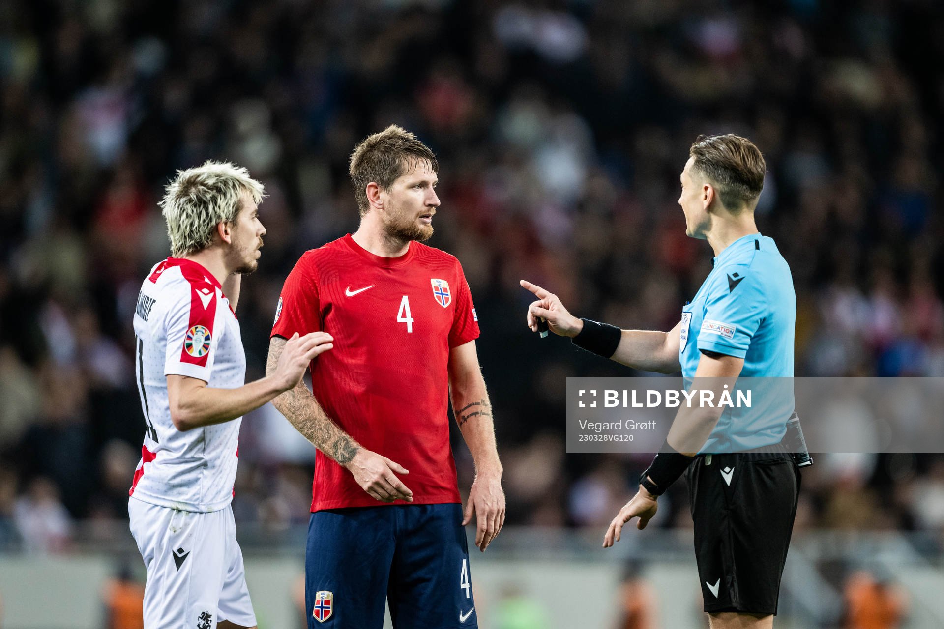 Stefan Strandberg of Norway and Referee Andris Treimanis