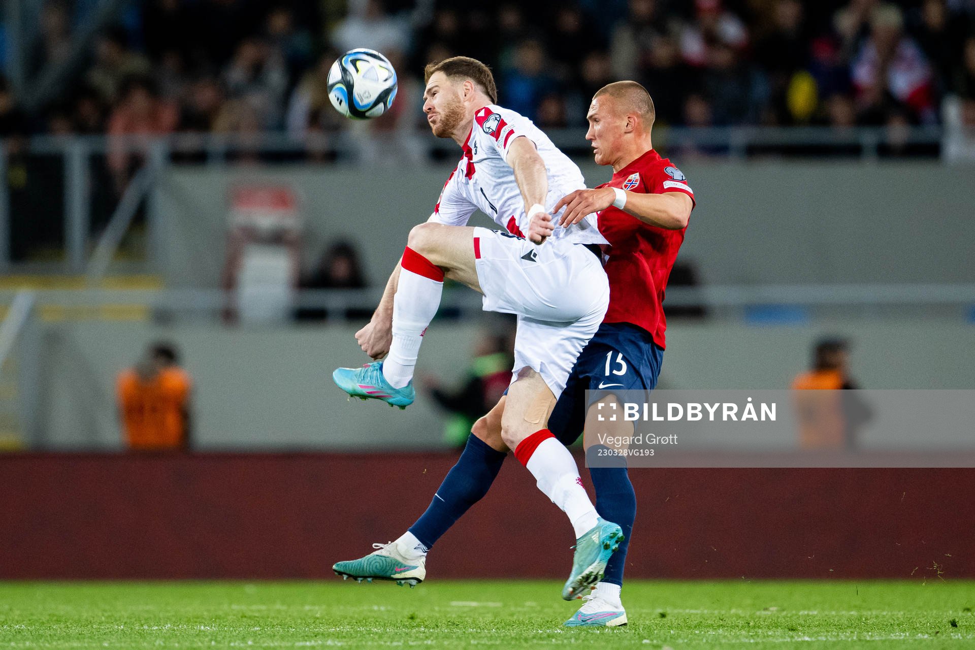 Budu Zivzivadze of Georgia and Leo Skiri Østigård of Norway during the UEFA Euro Qualifier football match between Georgia and Norway on March 28, 2023 in Batumi.