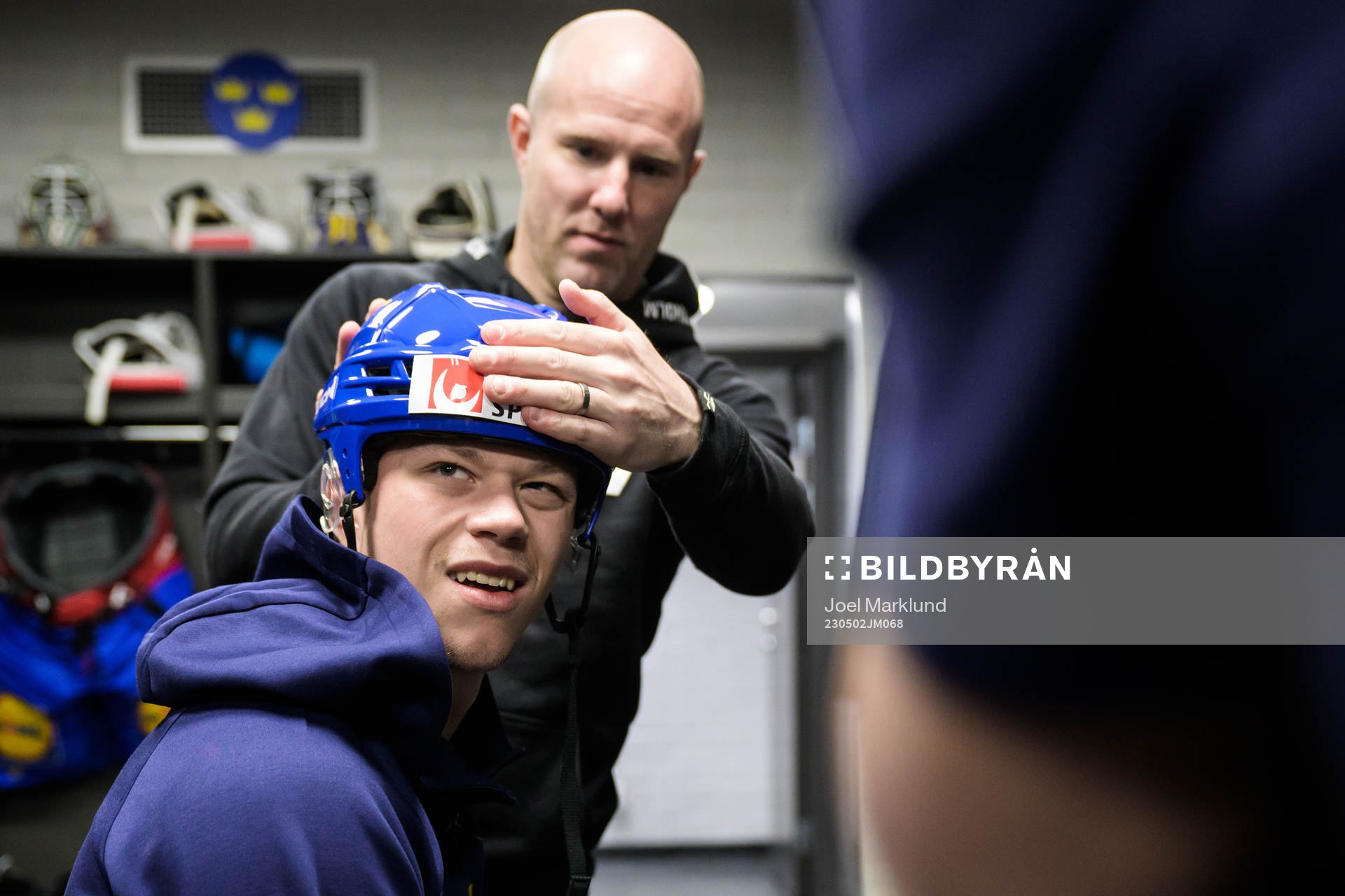 Lucas Raymond of Sweden gets his helmet adjusted