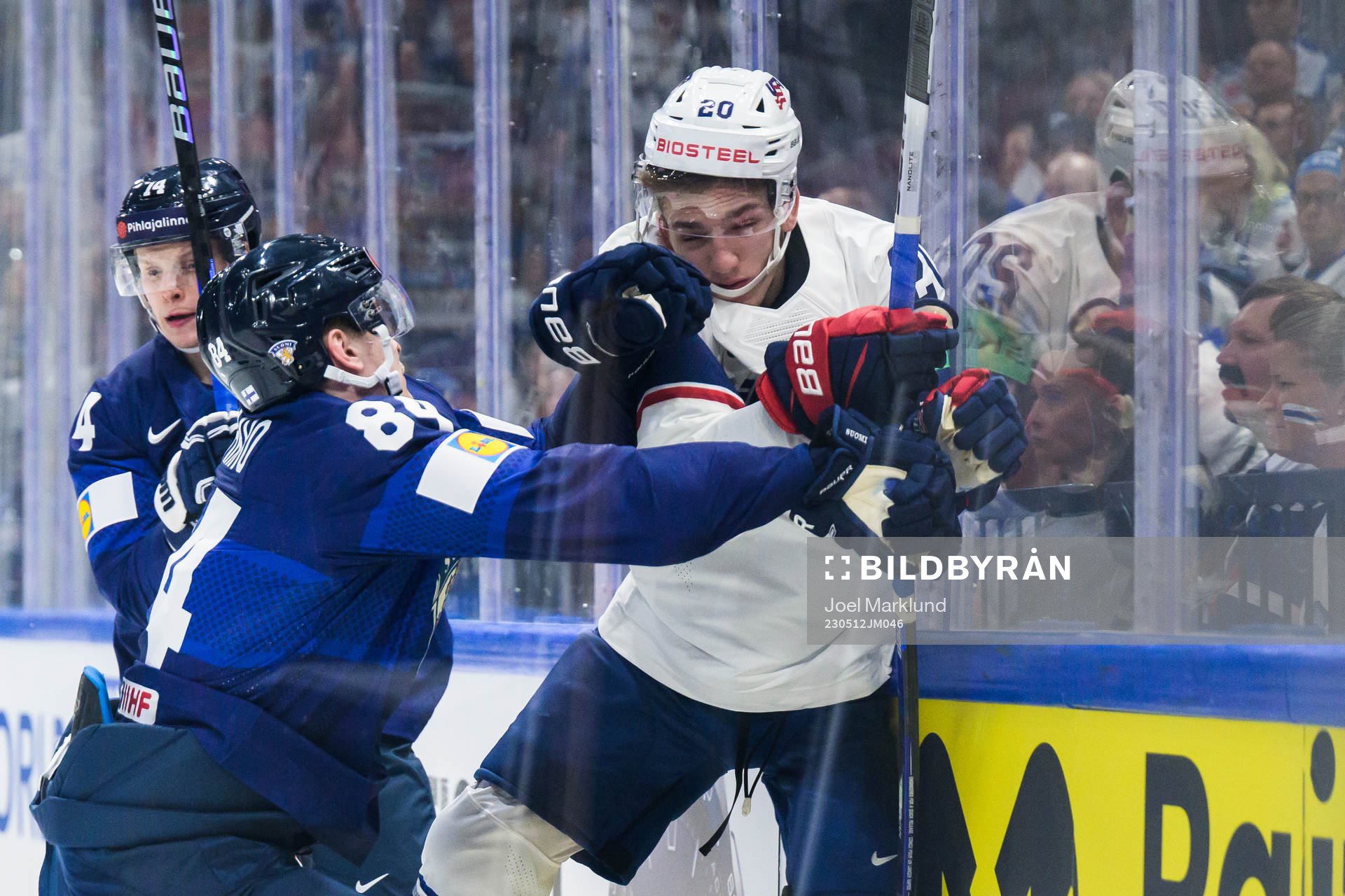Kaapo Kakko of Finland tackles Lane Hutson of USA
