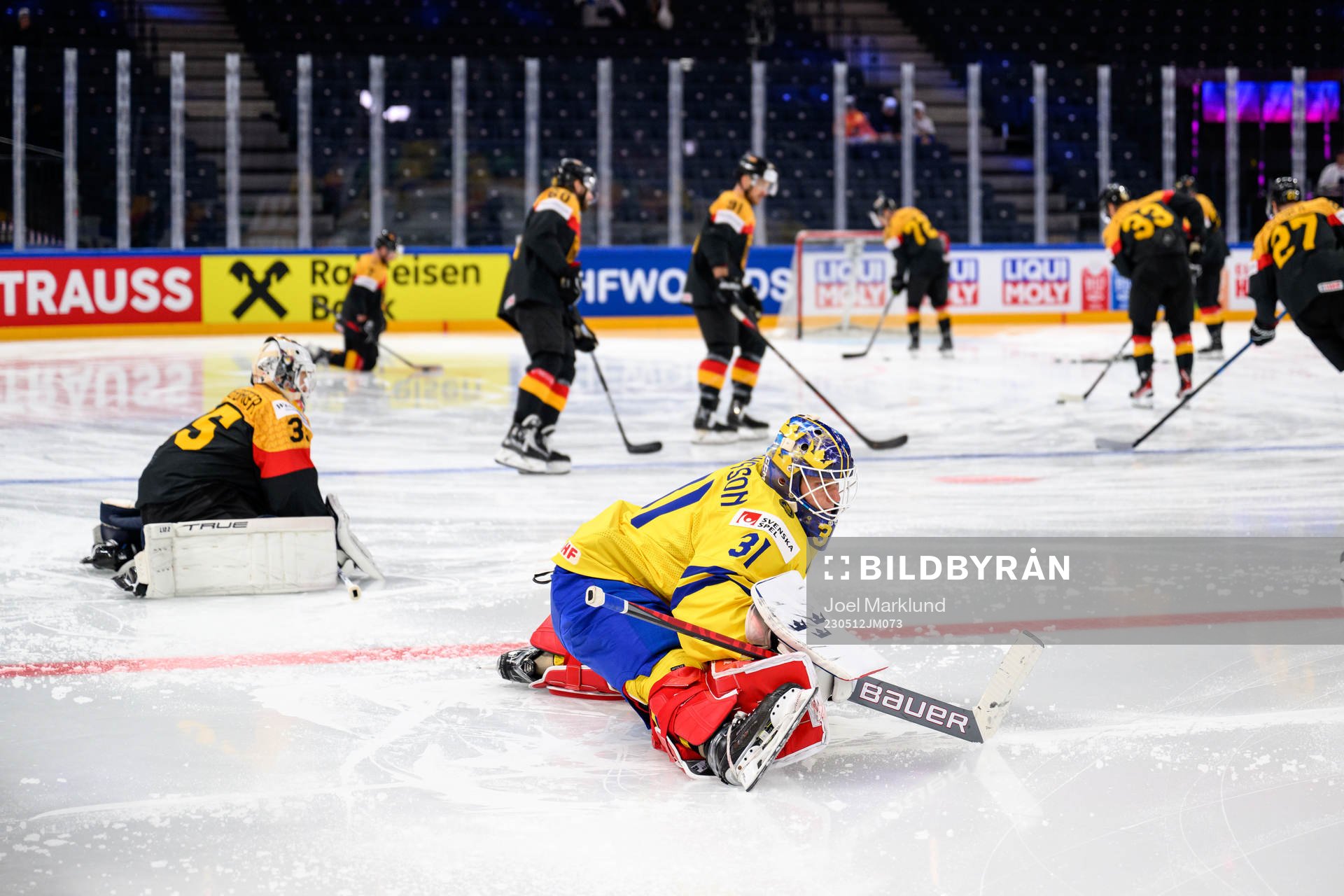 Mathias Niederbergerof Germany and goaltender Lars