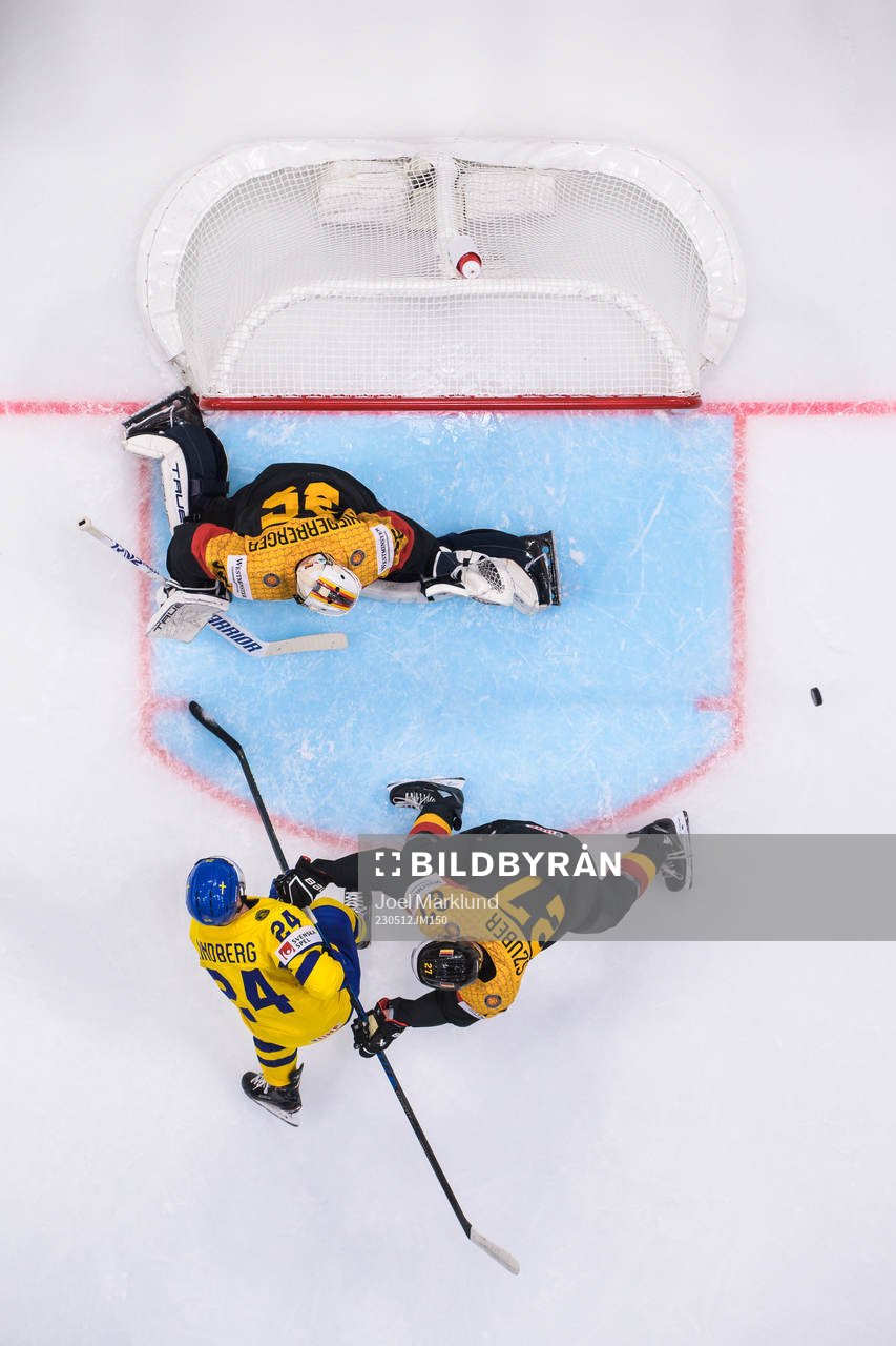 Oscar Lindberg of Sweden challenges goaltender Mathias