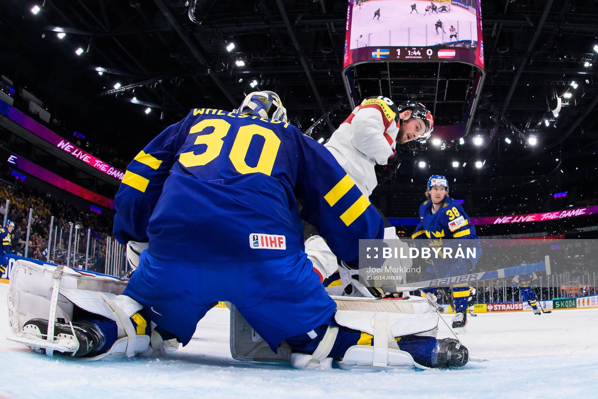 Goaltender Jesper Wallstedt of Sweden is being challenged