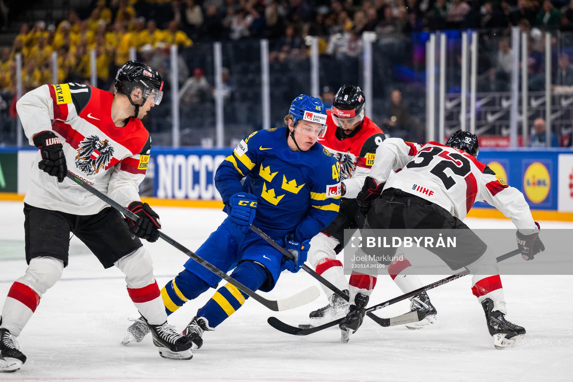 Lukas Haudum and Bernd Wolf of Austria defend against