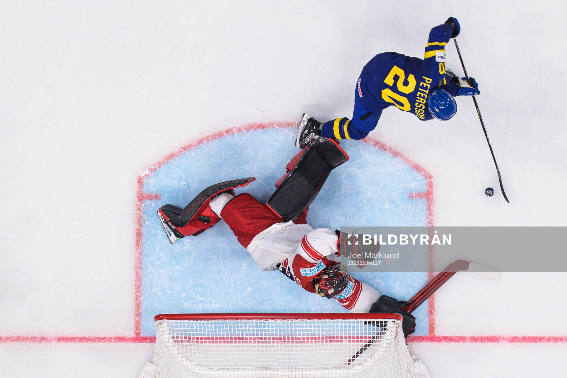 Goaltender George Sørensen of Denmark is being challenged