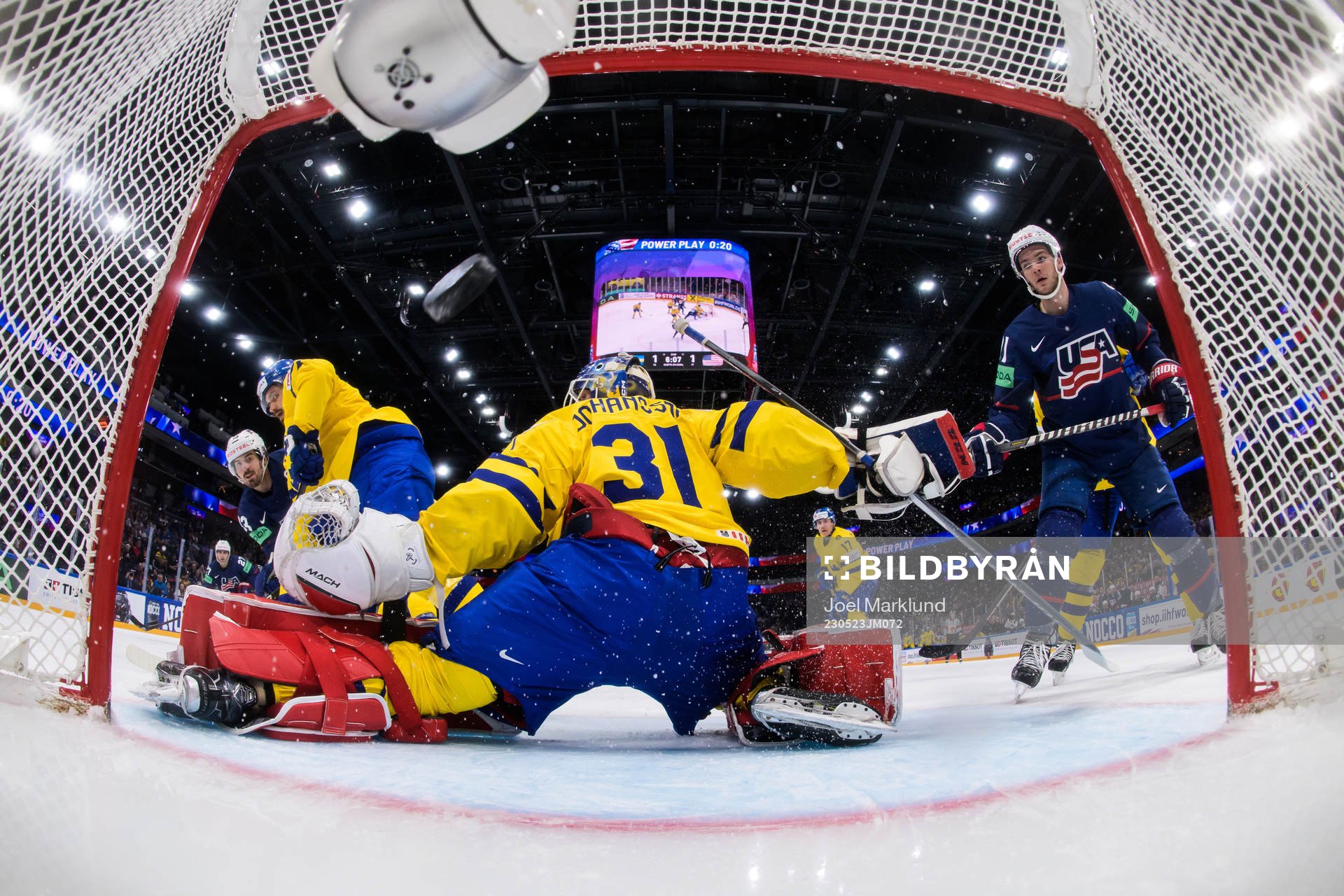 Conor Garland of USA scores 1-2 behind goaltender Lars
