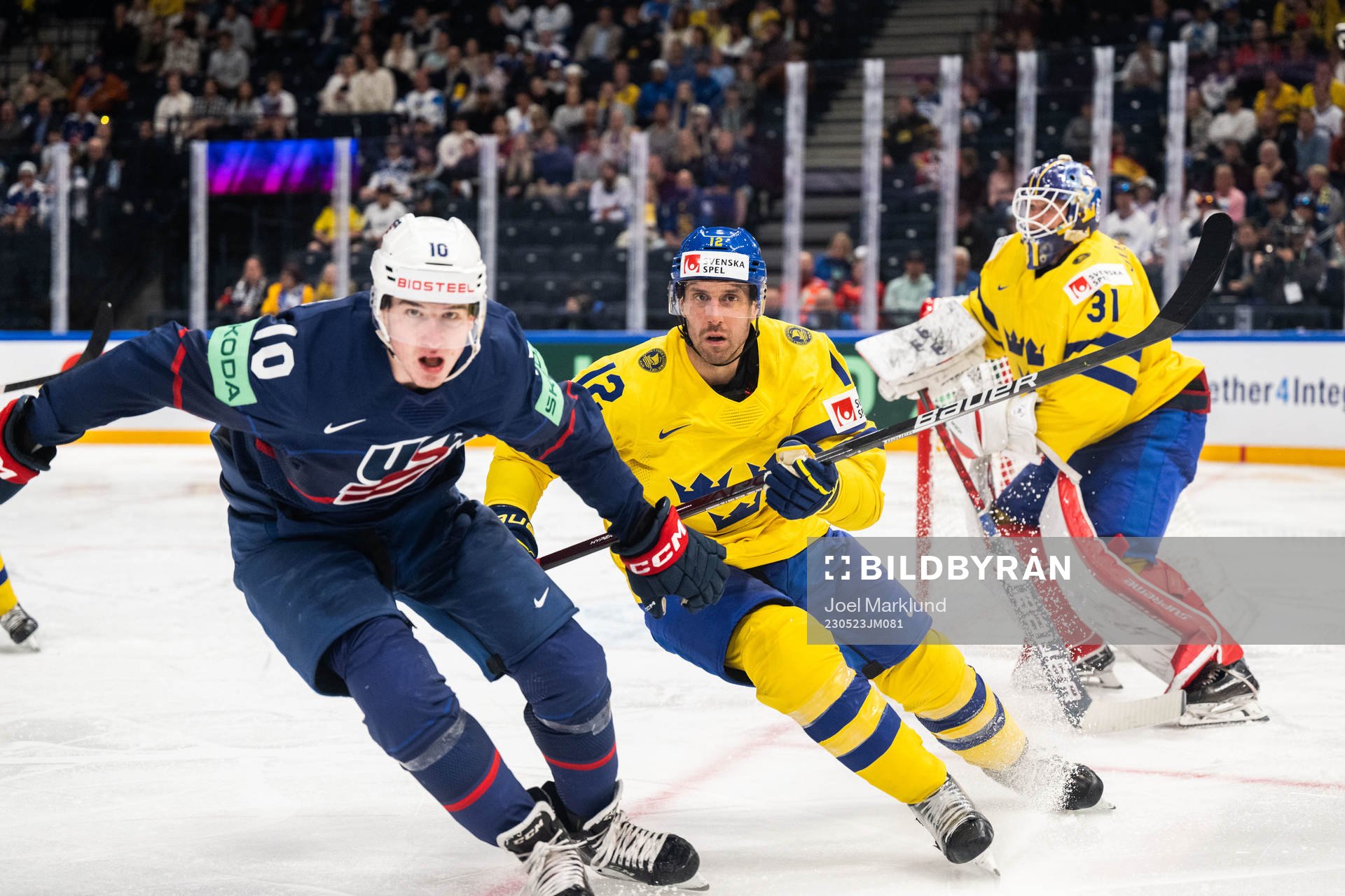 Drew O'Connor of USA against Patrik Nemeth and goaltender