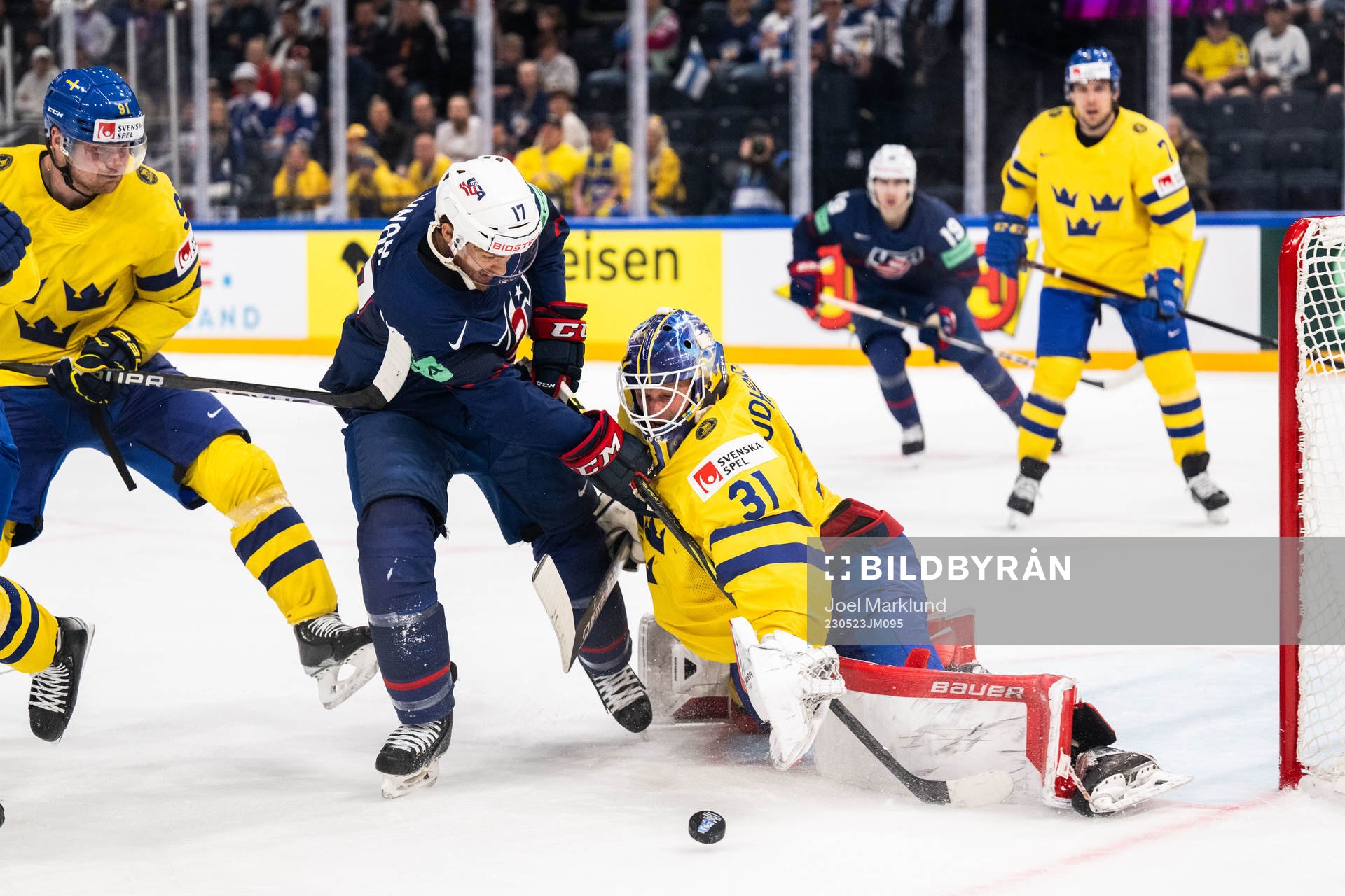 T.J. Tynan of USA and goaltender Lars Johansson of Sweden