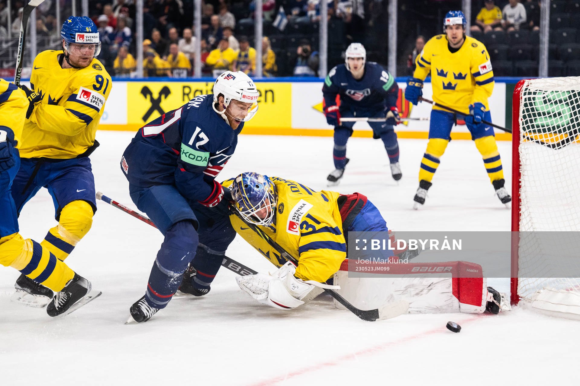 T.J. Tynan of USA and goaltender Lars Johansson of Sweden