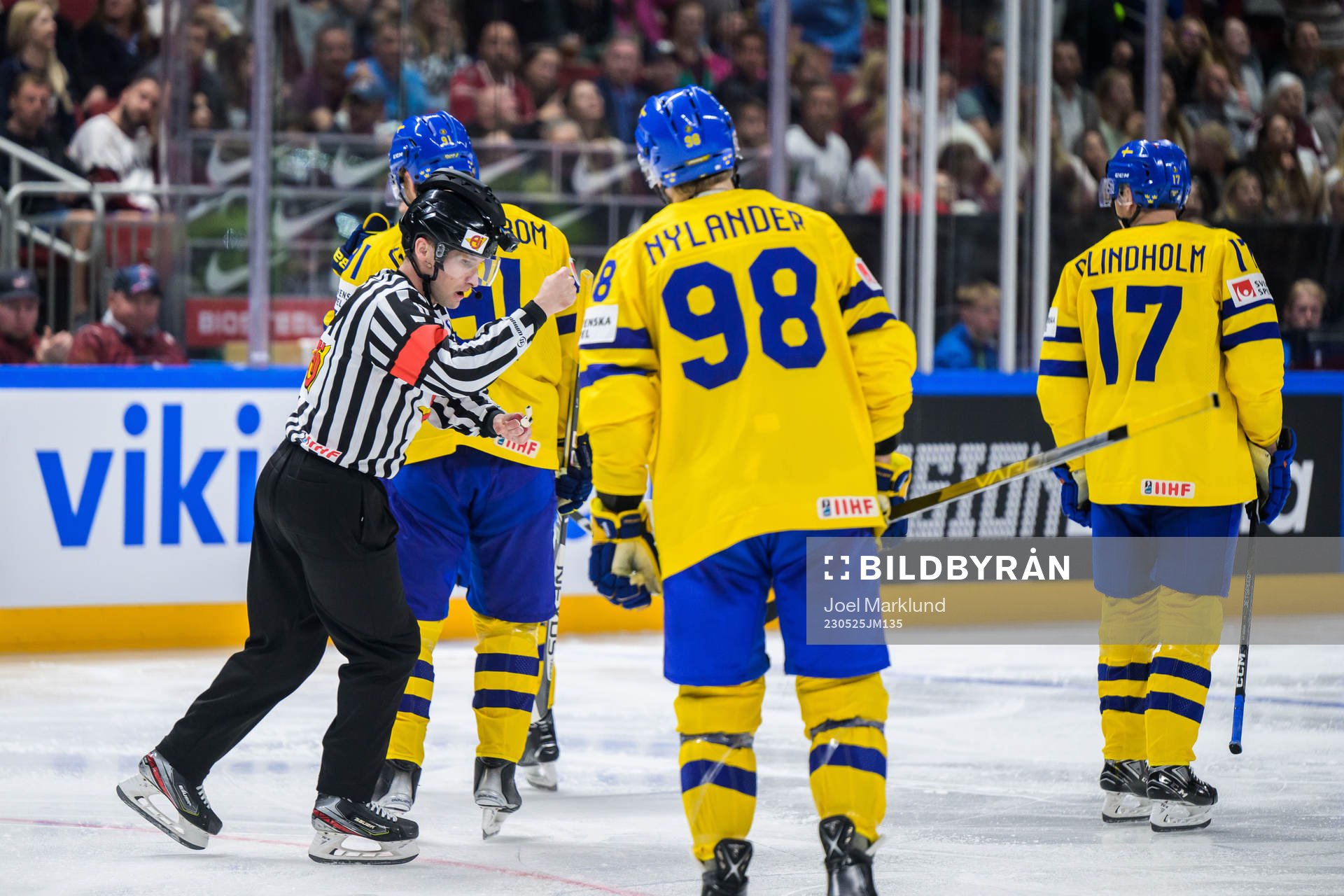 Referee Sean Macfarlane signals for a high stick and denies