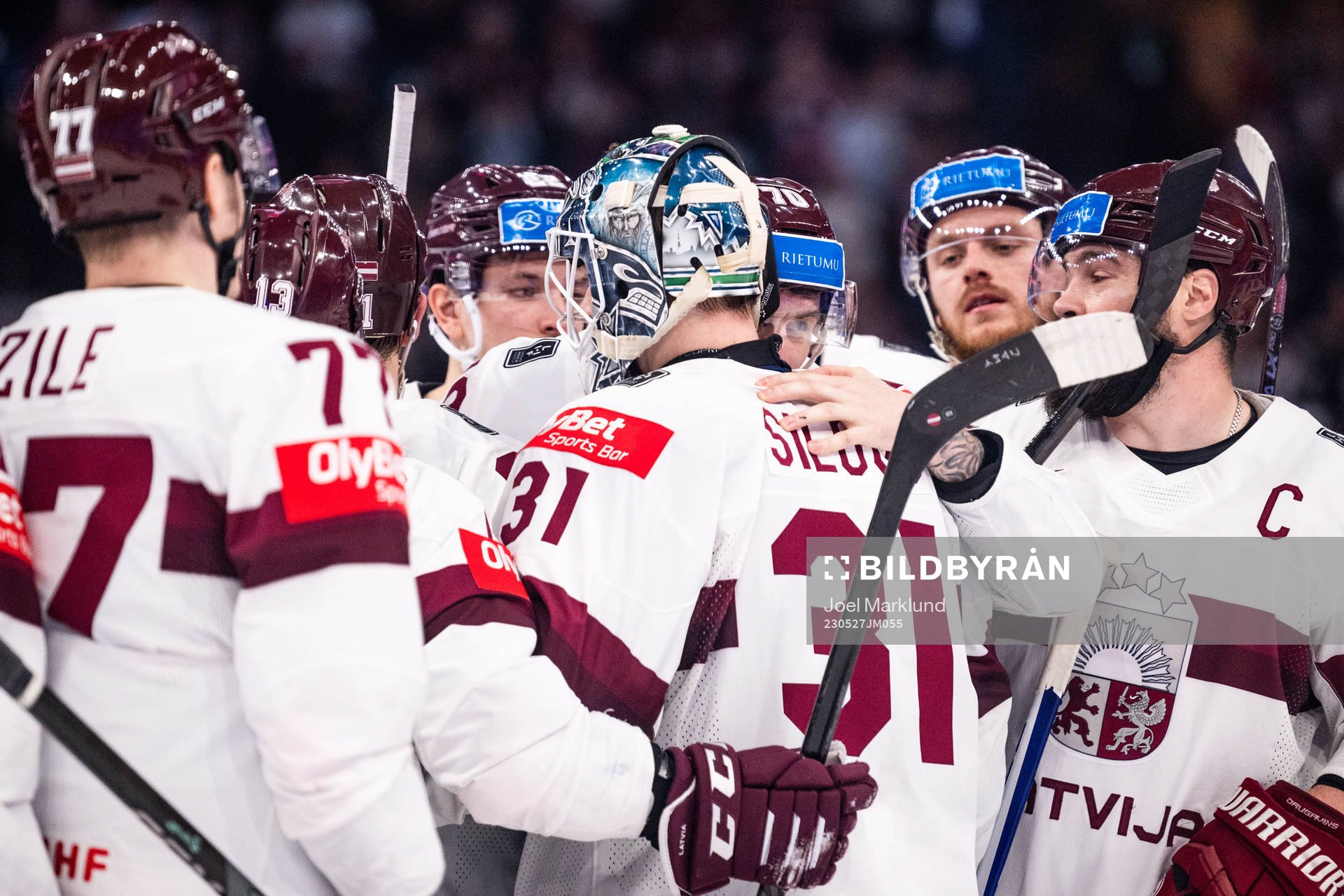 Goaltender Arturs Silovs and Miks Indrasis of Latvia hug