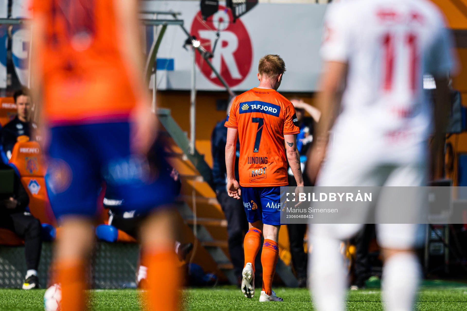 Kasper Lunding of Aalesund leaves the pitch with an injury