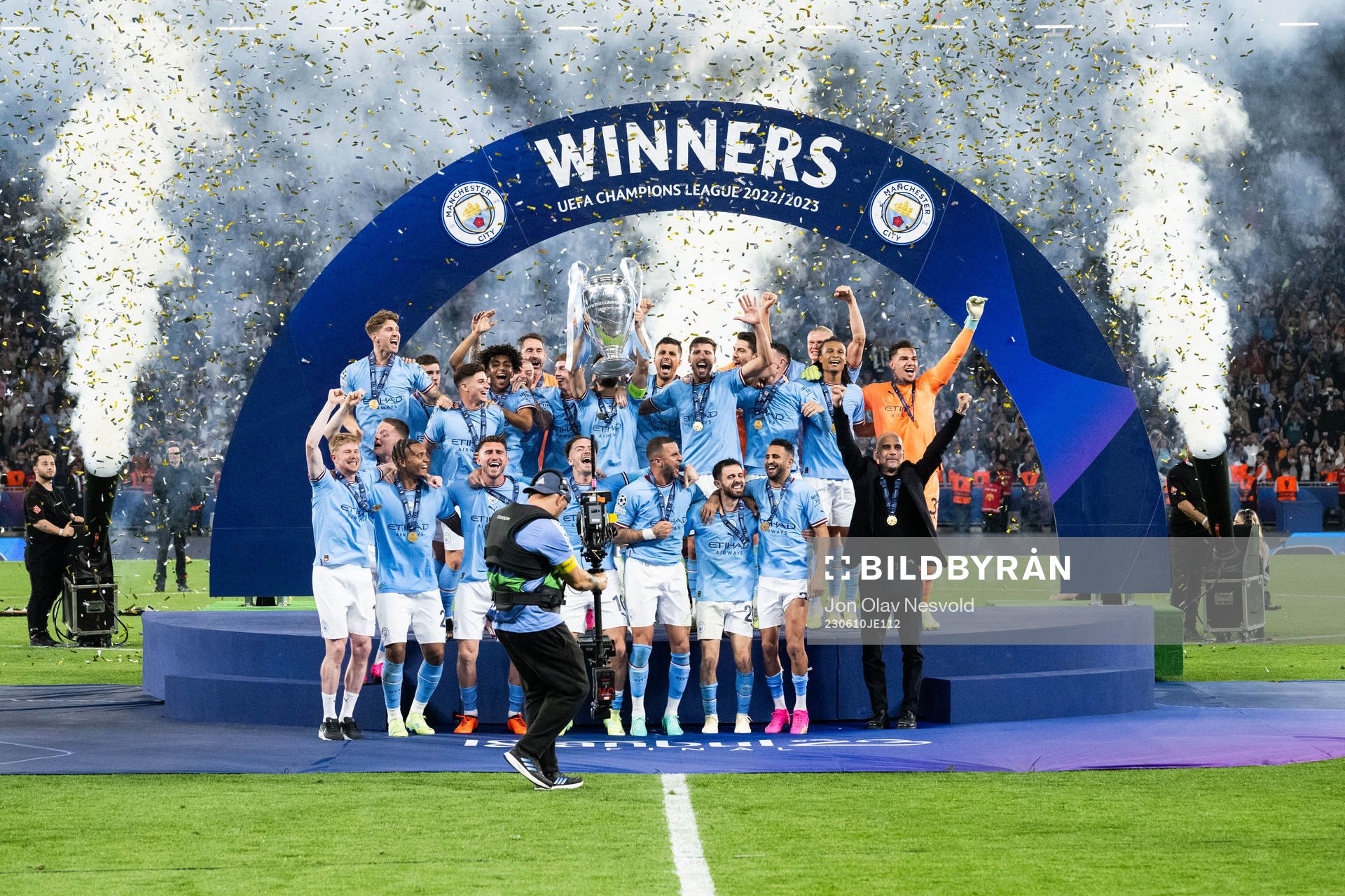 Players of Manchester City celebrate with the trophy