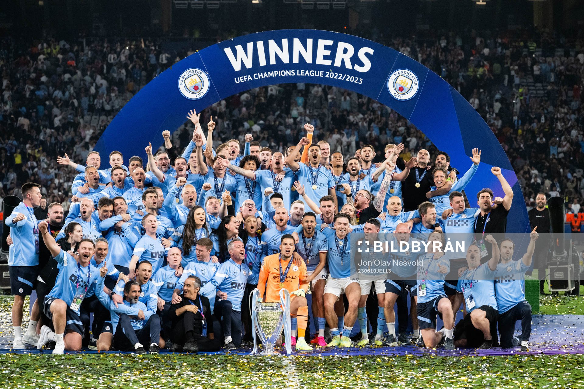 Players of Manchester City celebrate with the trophy