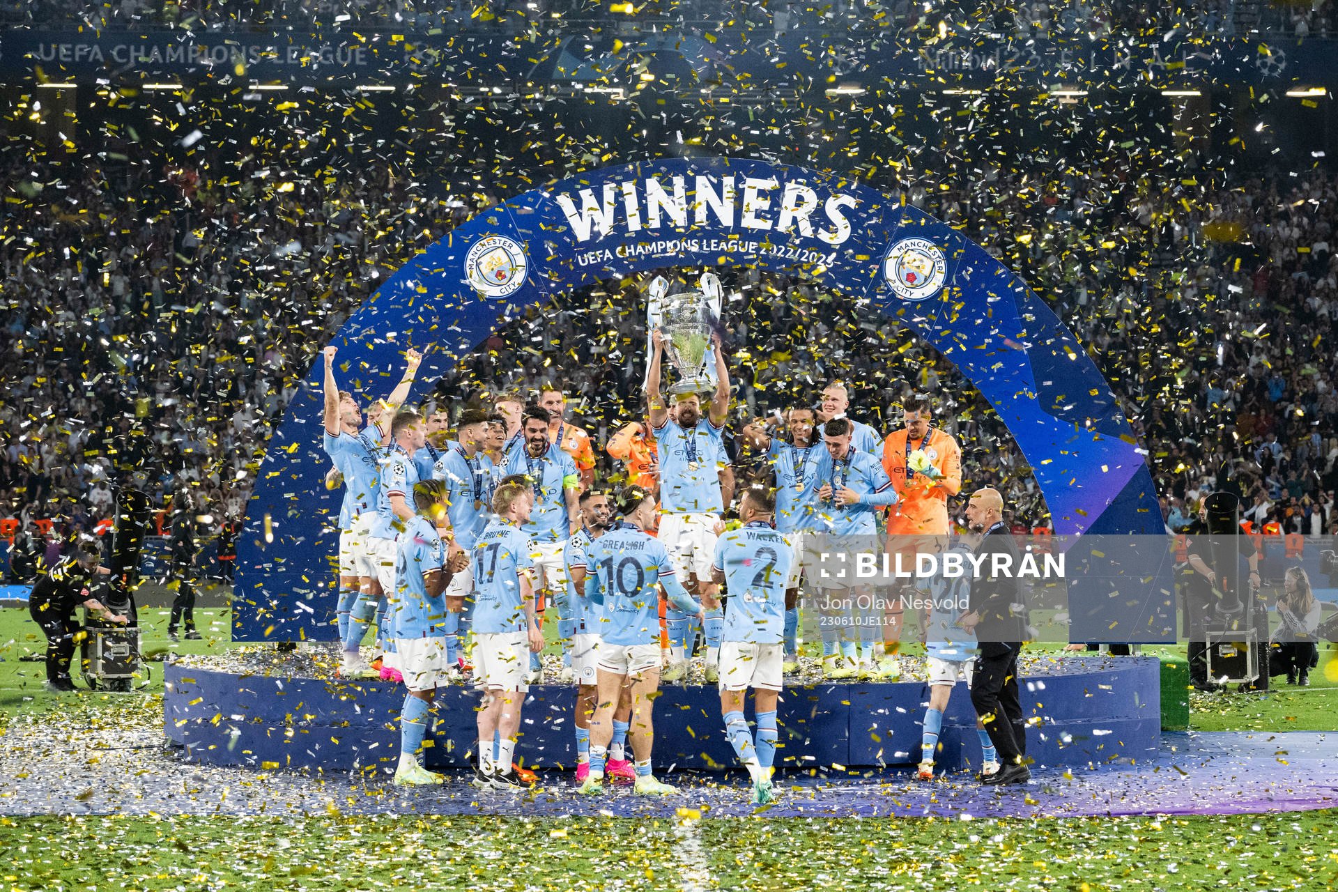 Players of Manchester City celebrate with the trophy