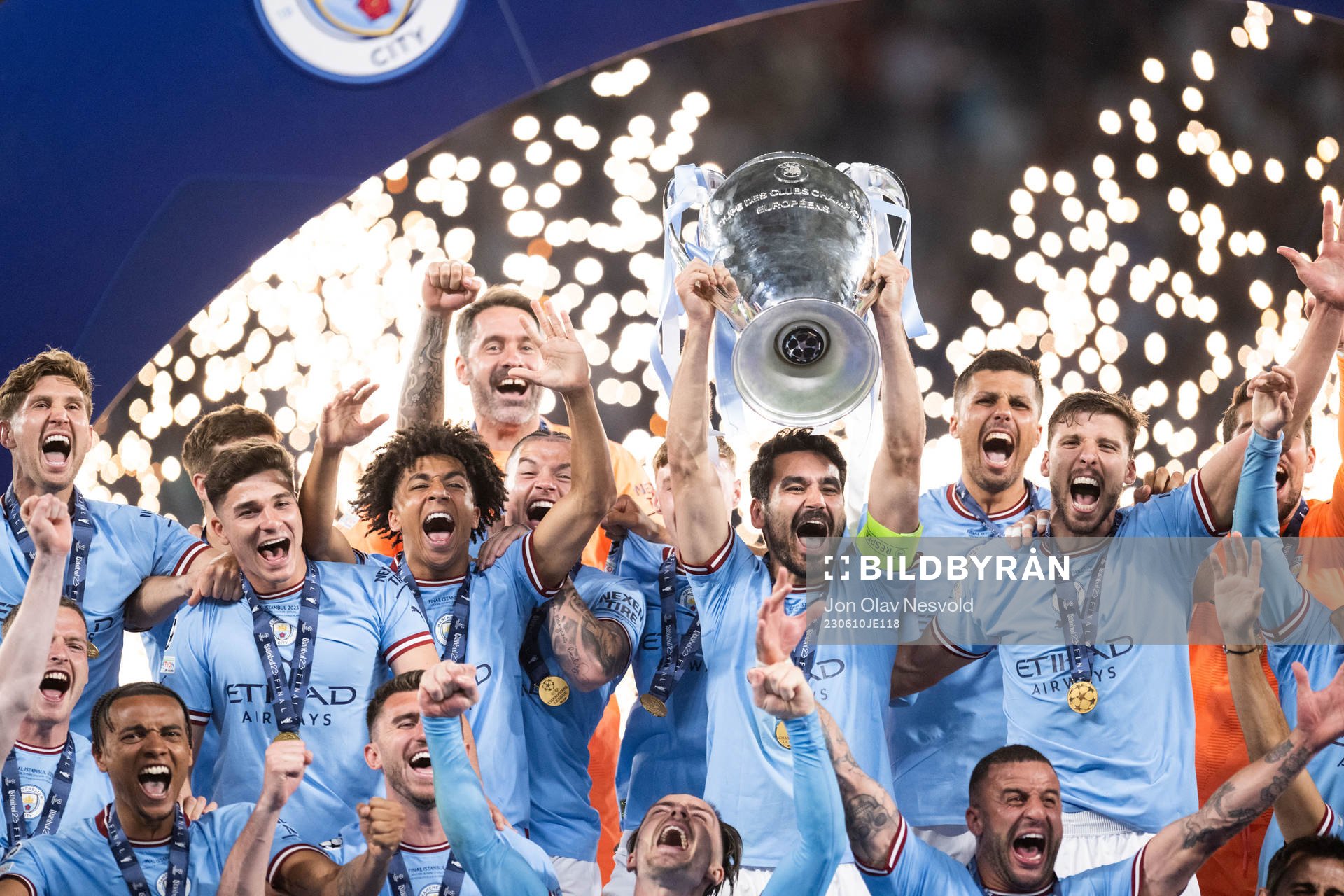 Players of Manchester City celebrate with the trophy