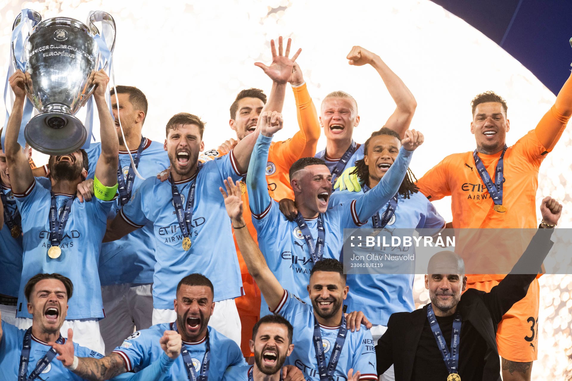 Players of Manchester City celebrate with the trophy