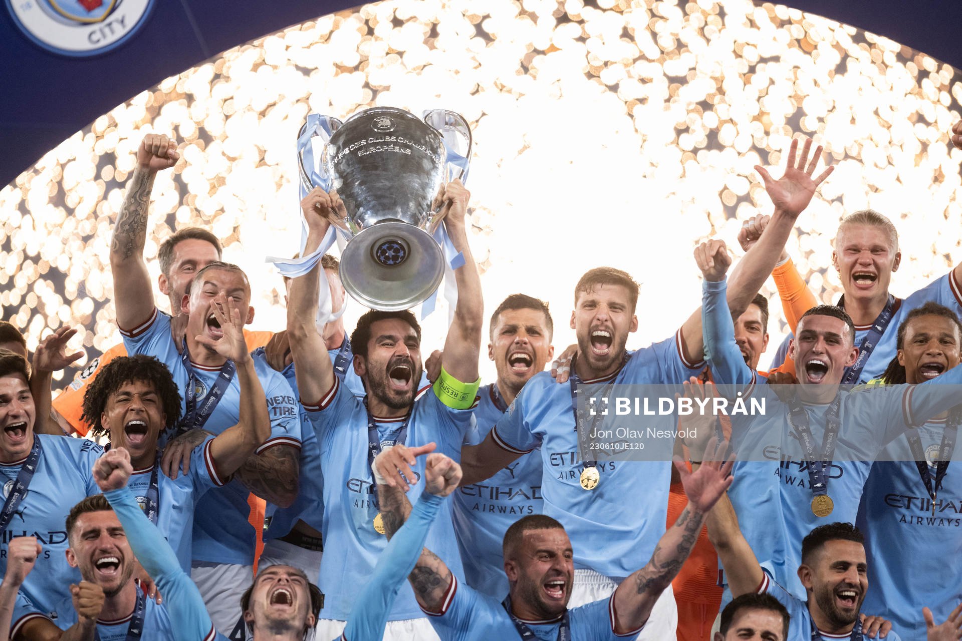 Players of Manchester City celebrate with the trophy